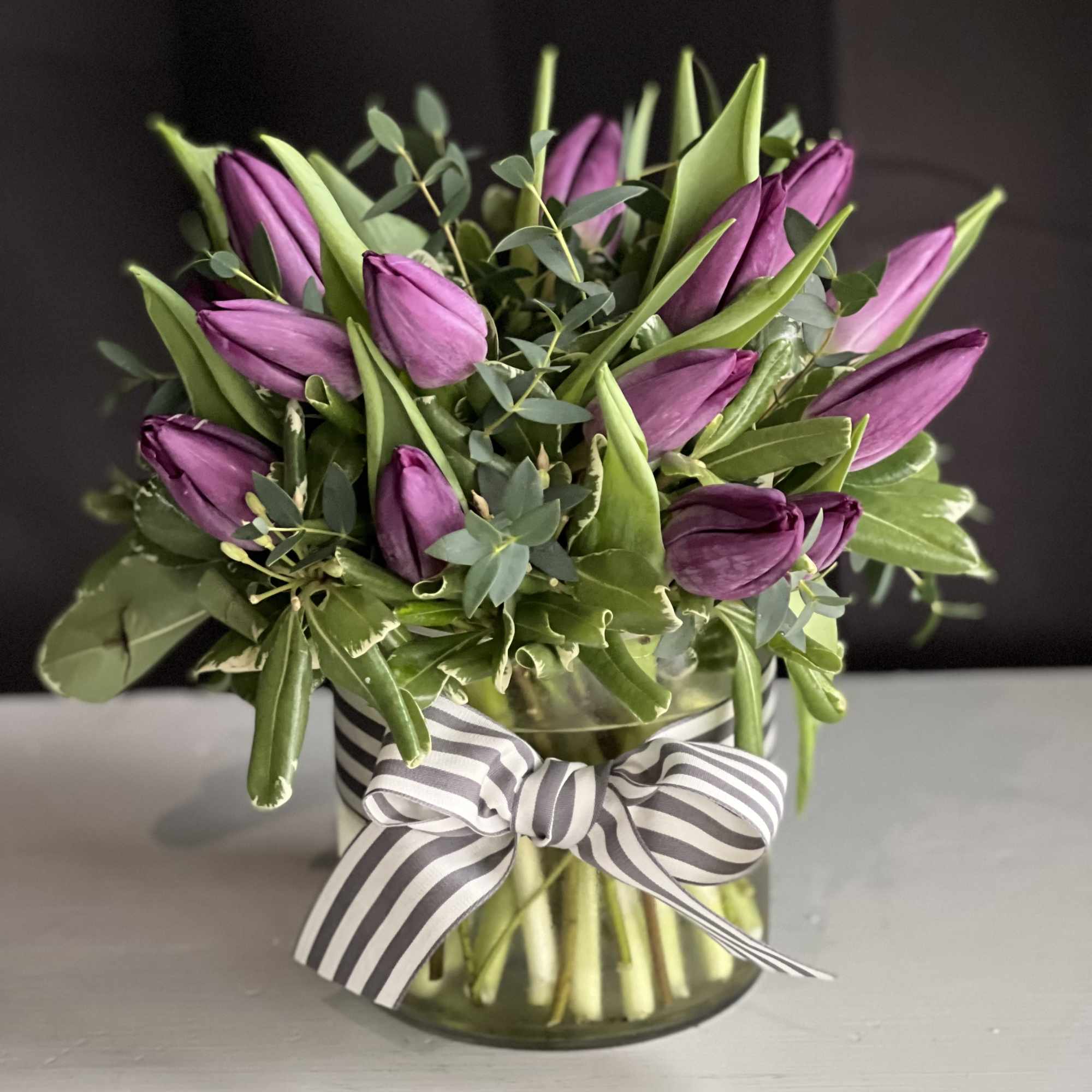 20 Tulips designed in vase with ribbon.

