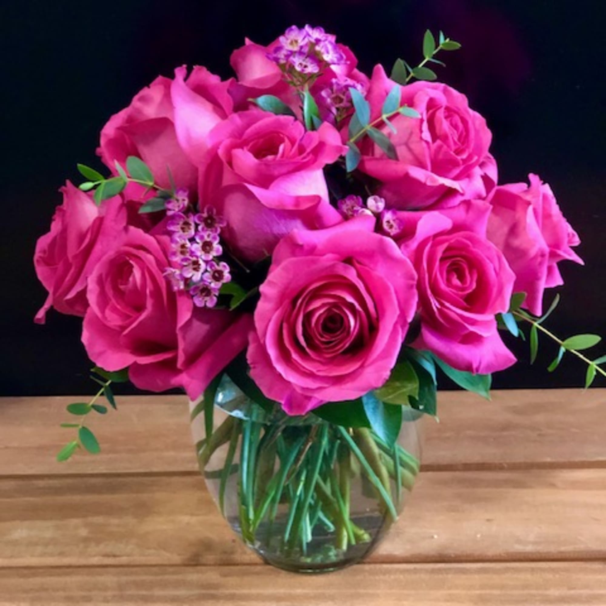 12 premium hot pink roses in a low and lush style

