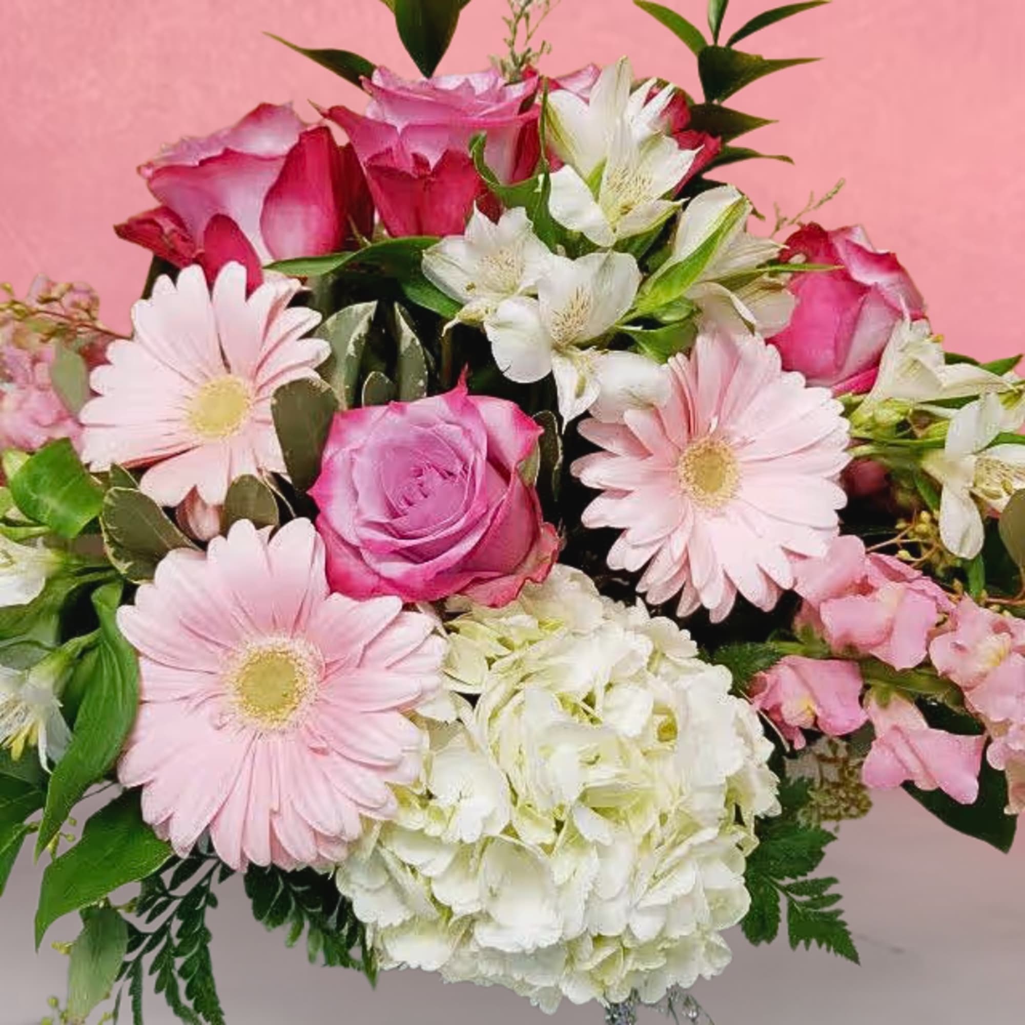 Pink roses and pale daisies with white alstroemeria in a bouquet