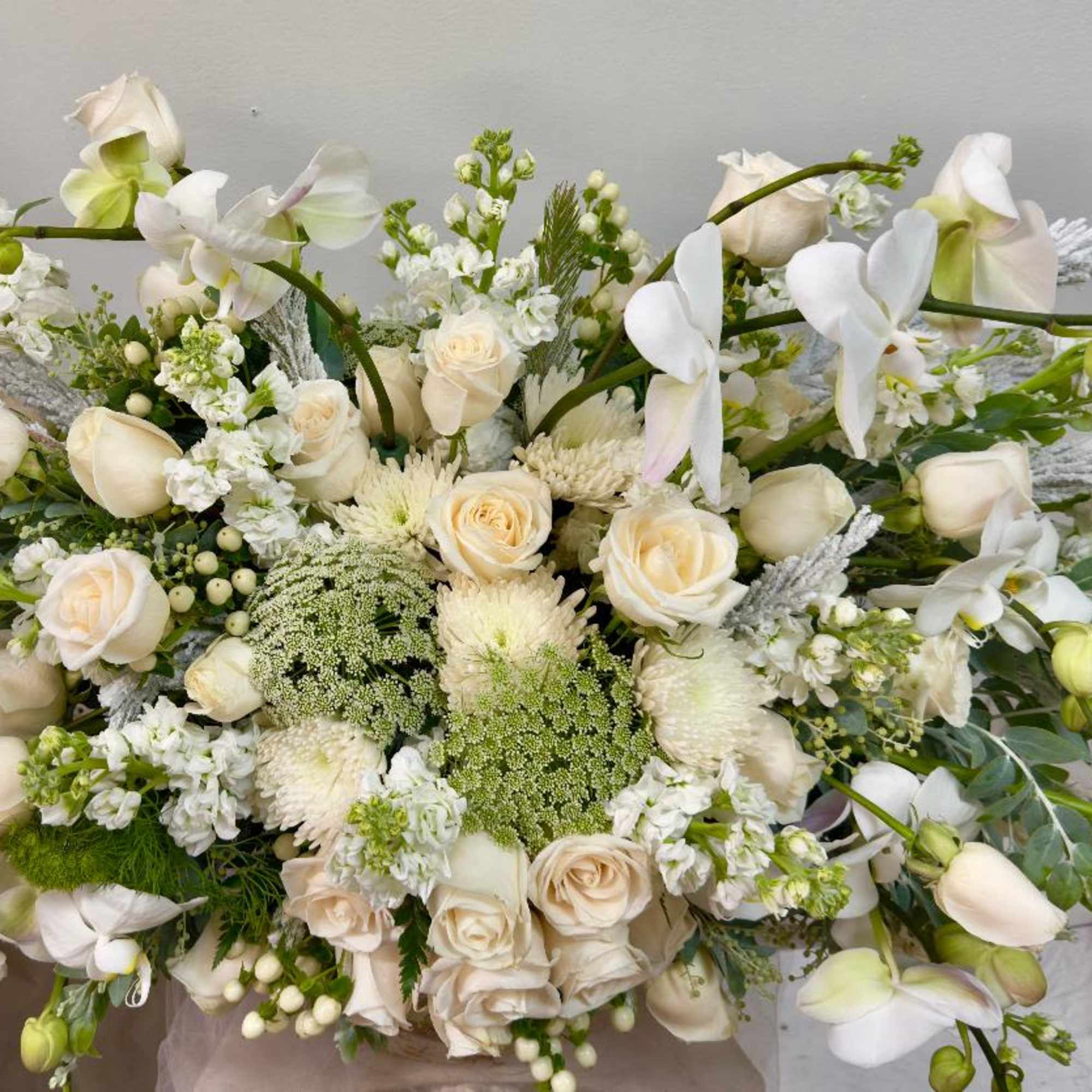 White floral bouquet with roses and orchids
