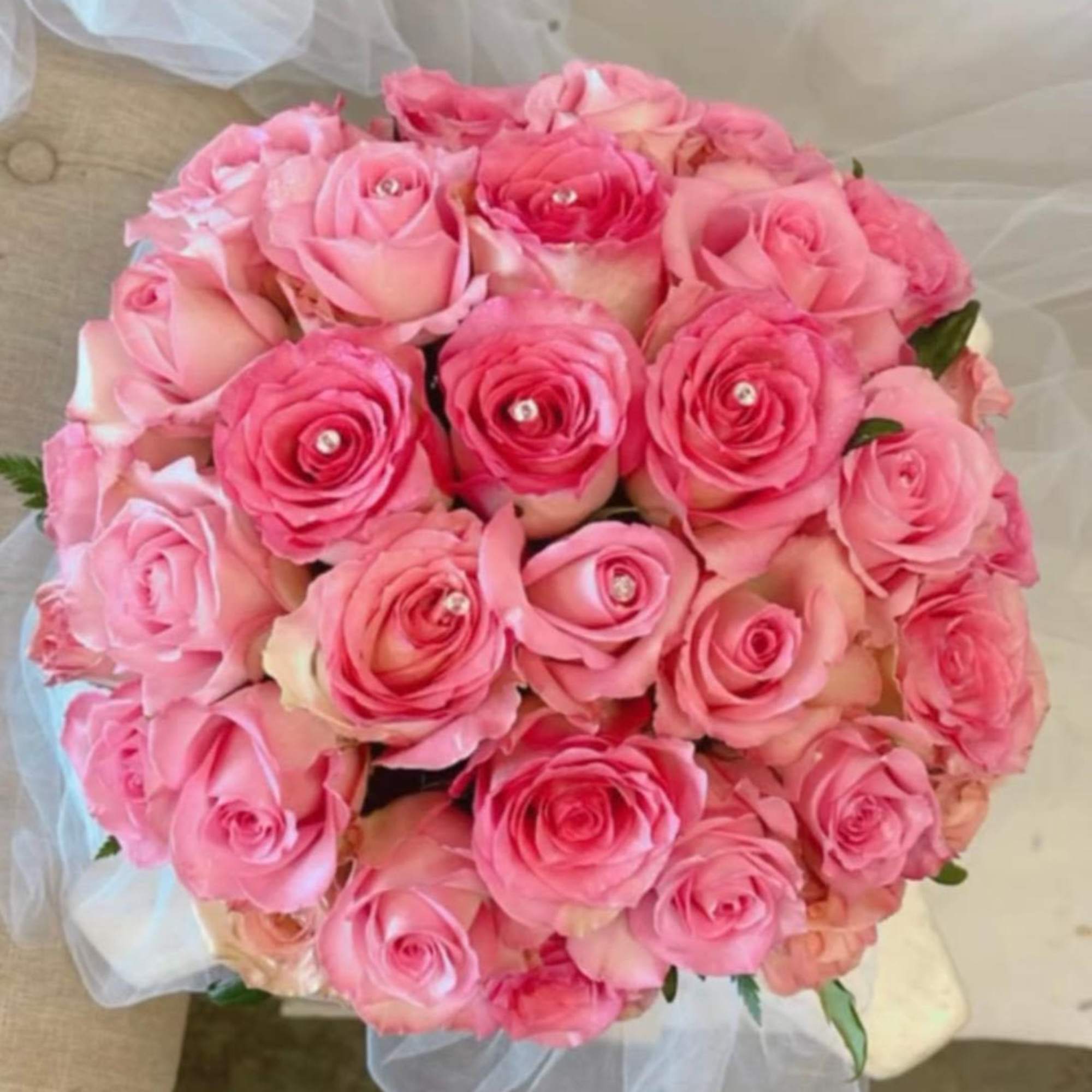 Round bouquet of pink roses with clear gem centers