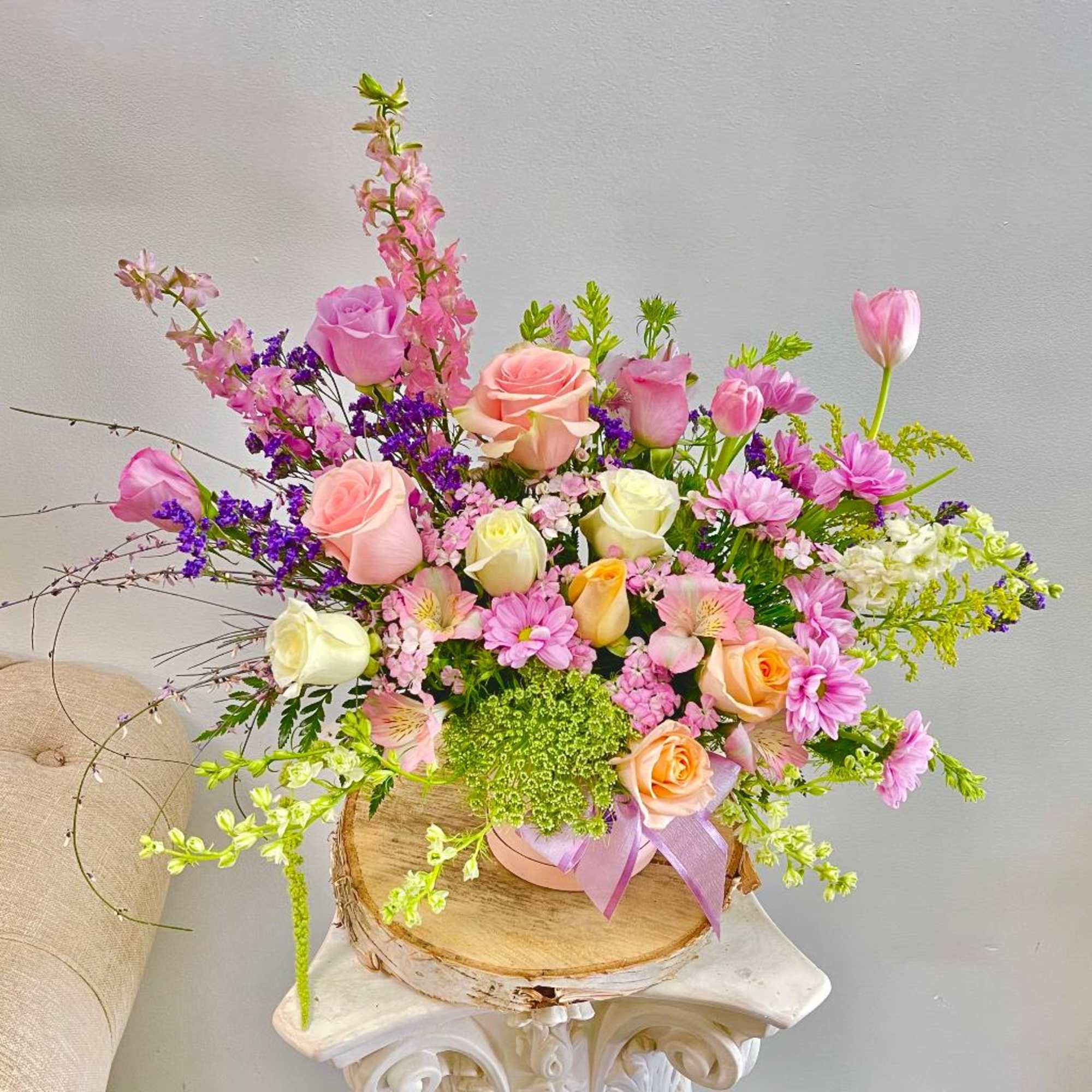 Mixed bouquet of pink and peach roses with purple and white flowers