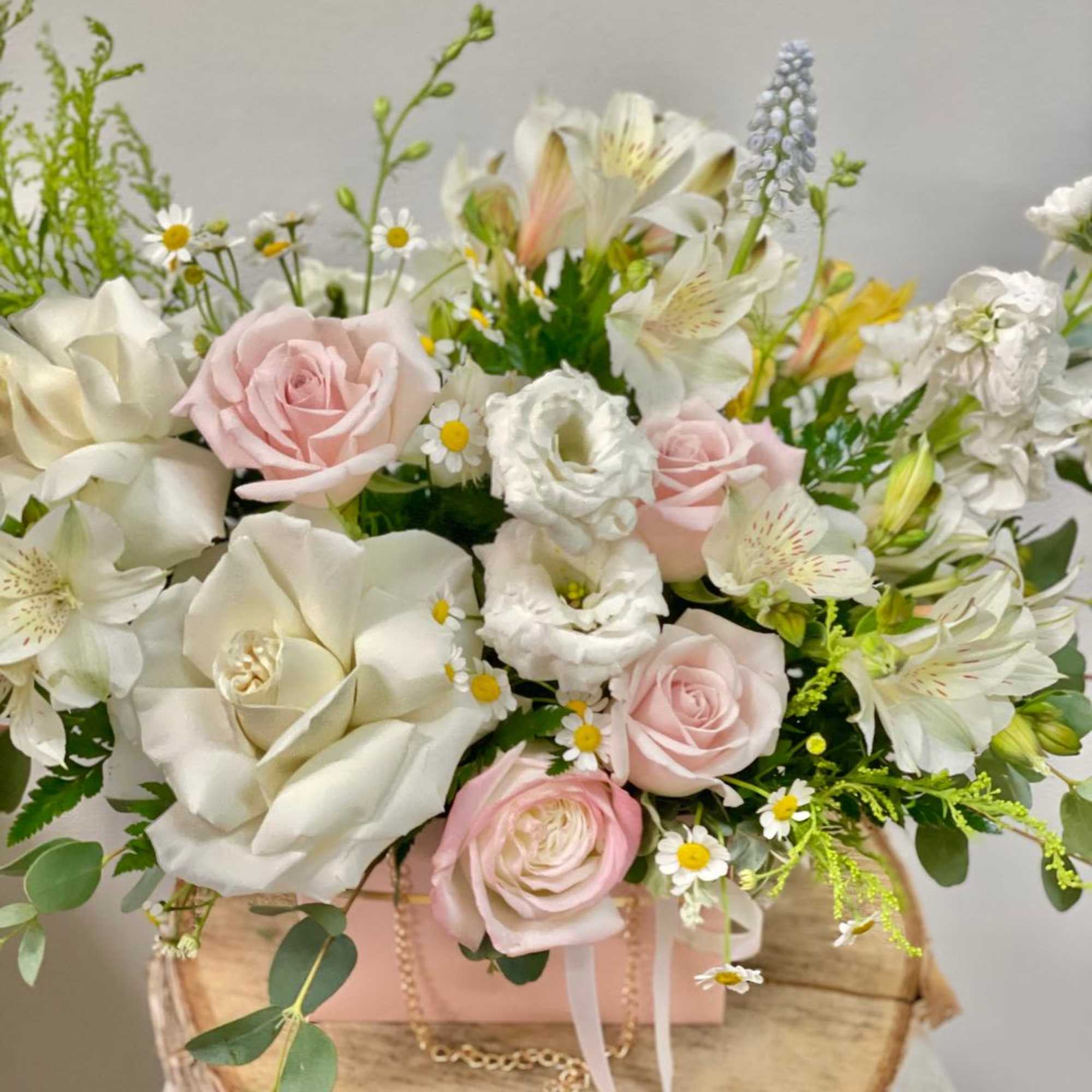 Bouquet of pale pink and white flowers in a gift box