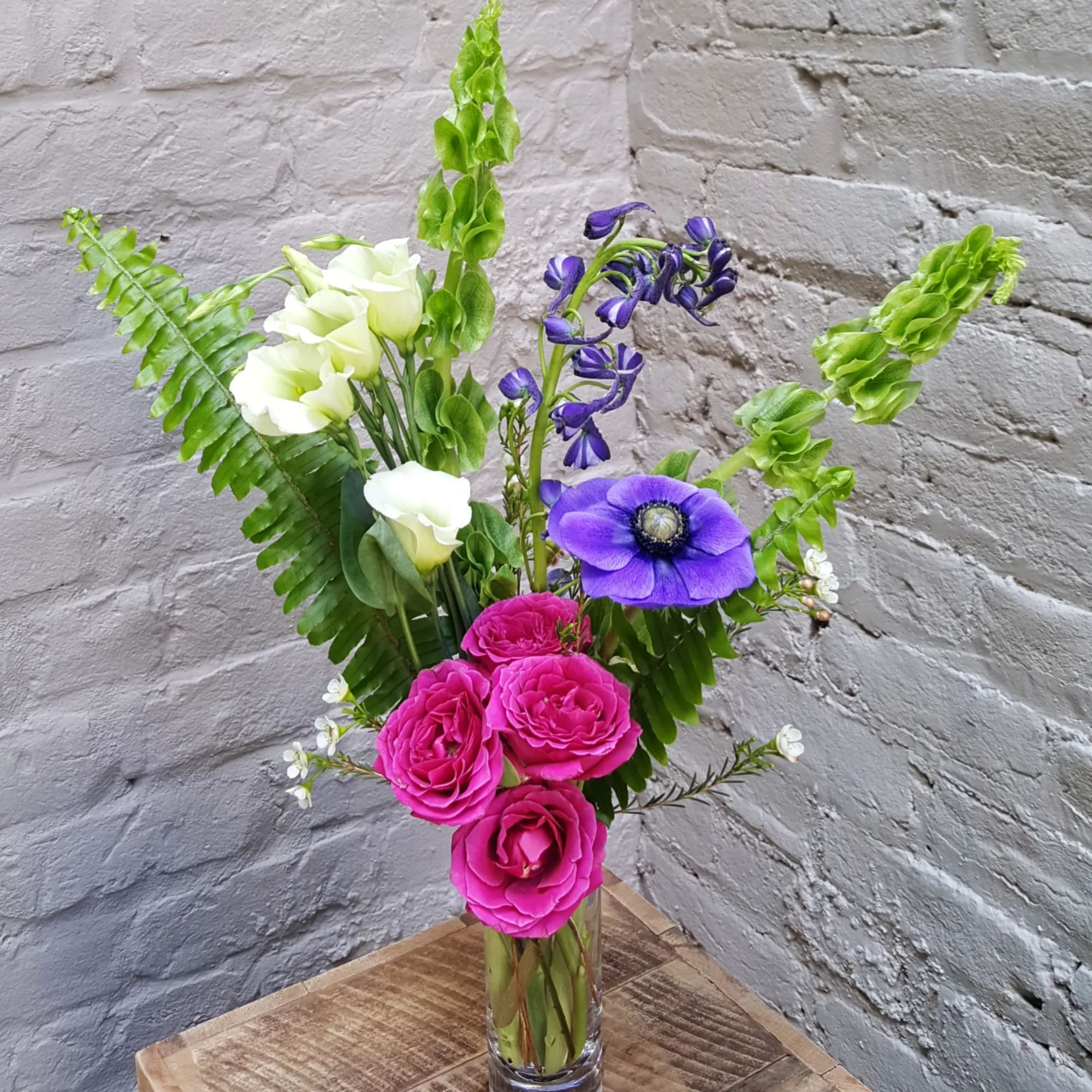 Tall bouquet of pink and white flowers in a clear glass vase