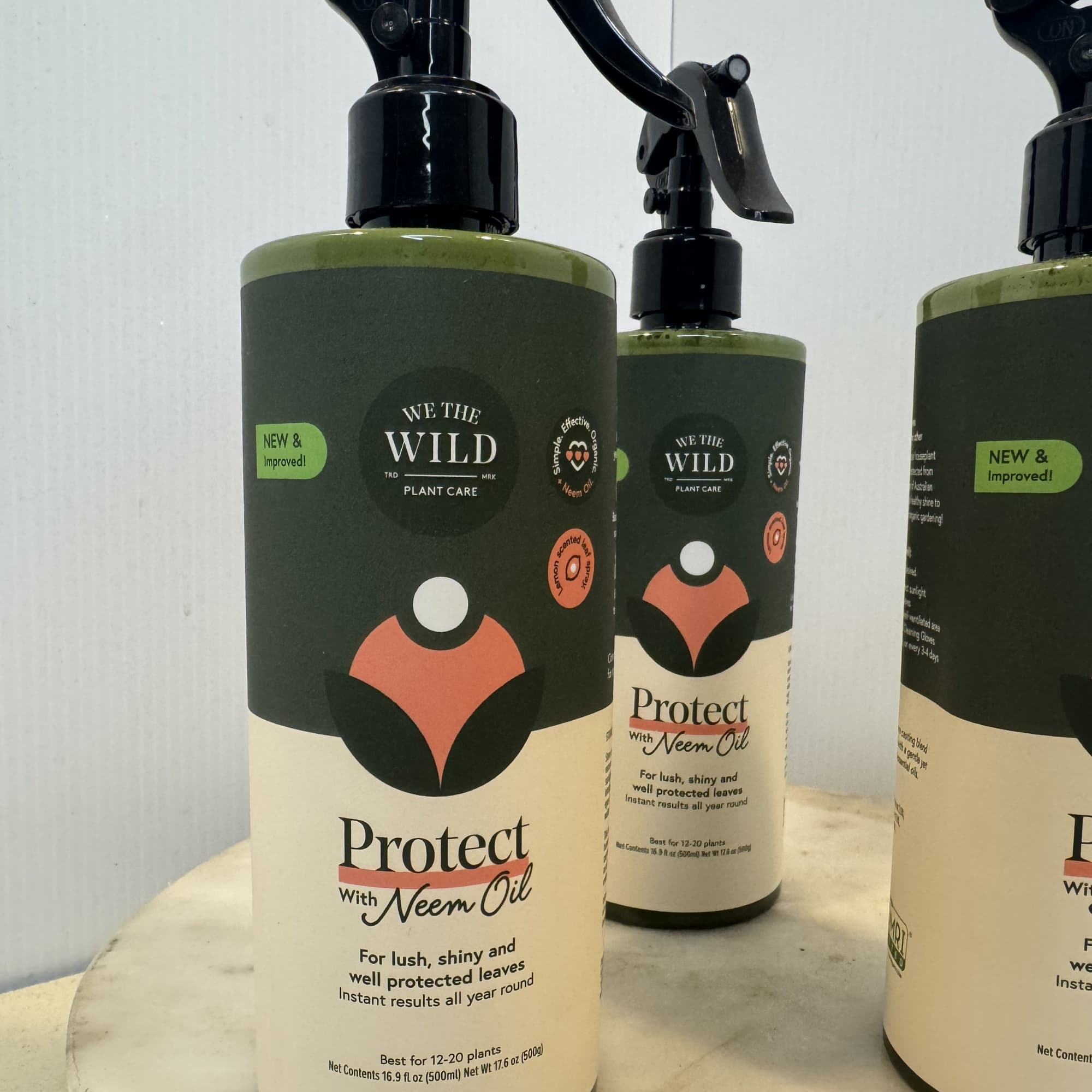 Three plant care spray bottles labeled Protect with Neem Oil