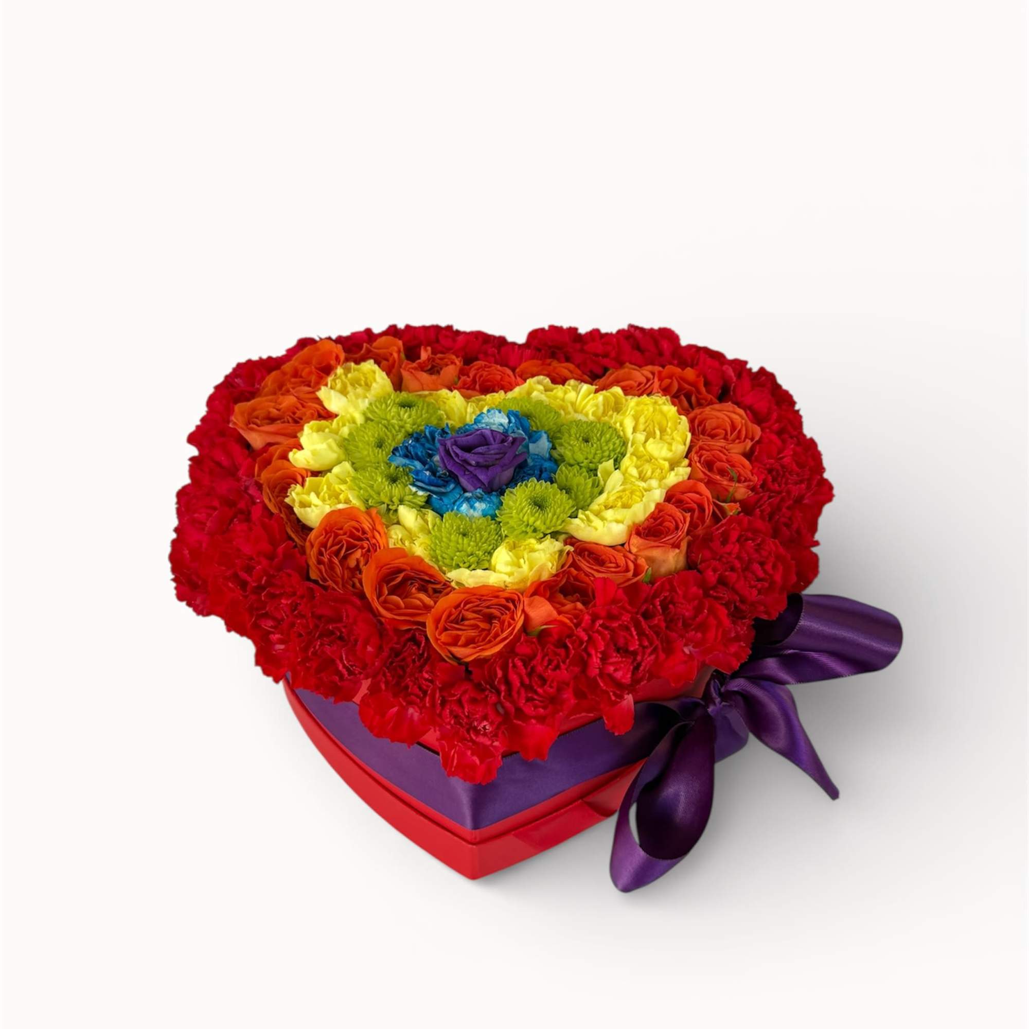 Heart-shaped box of multicolored roses and carnations with a purple ribbon