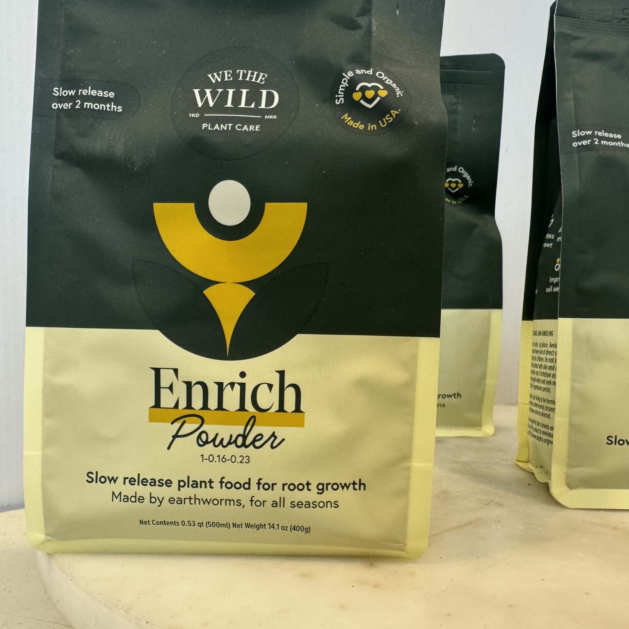 Bag of plant food powder on a table with similar bags behind it