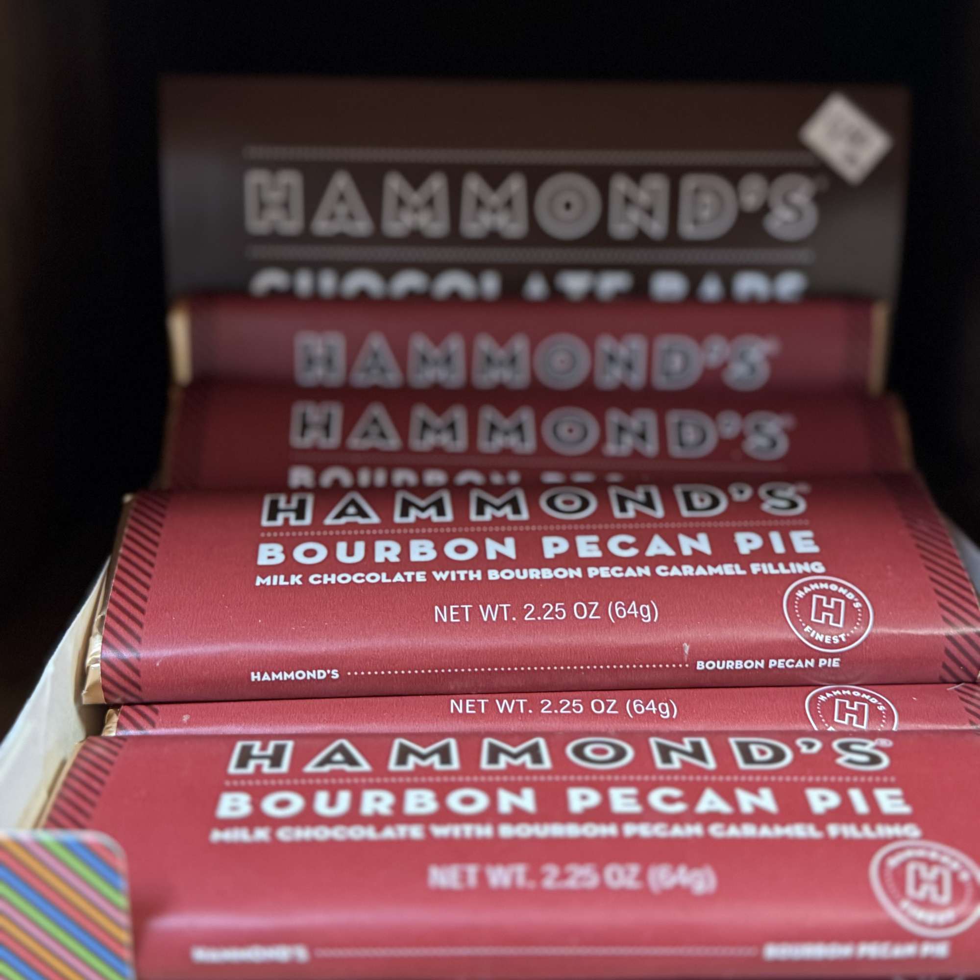 Stacked Hammond's bourbon pecan pie chocolate bars in red wrappers