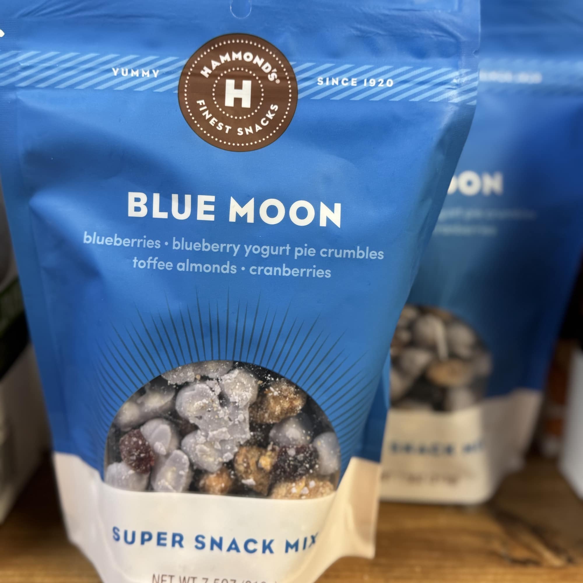 Blue snack mix bag with a clear window showing nuts and dried fruit