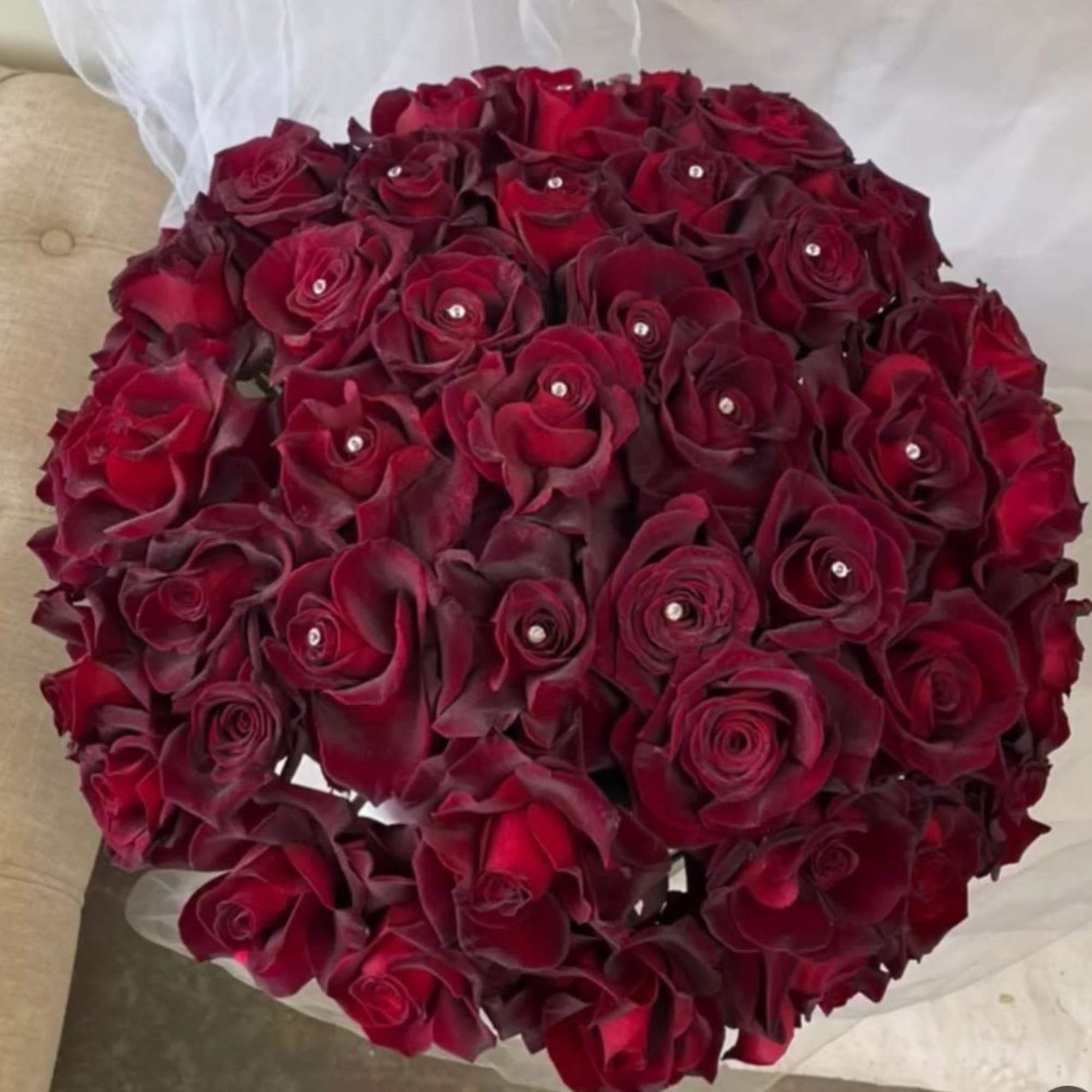 Round bouquet of deep red roses with small crystal accents