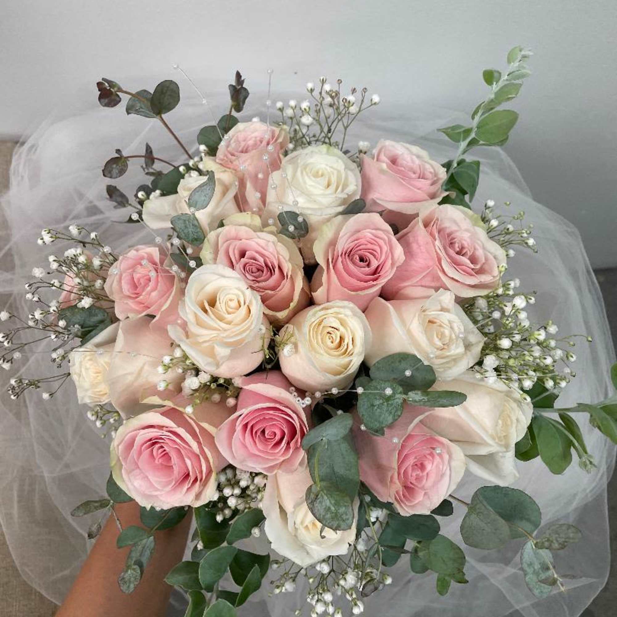 Pink and white rose bouquet with baby's breath and eucalyptus