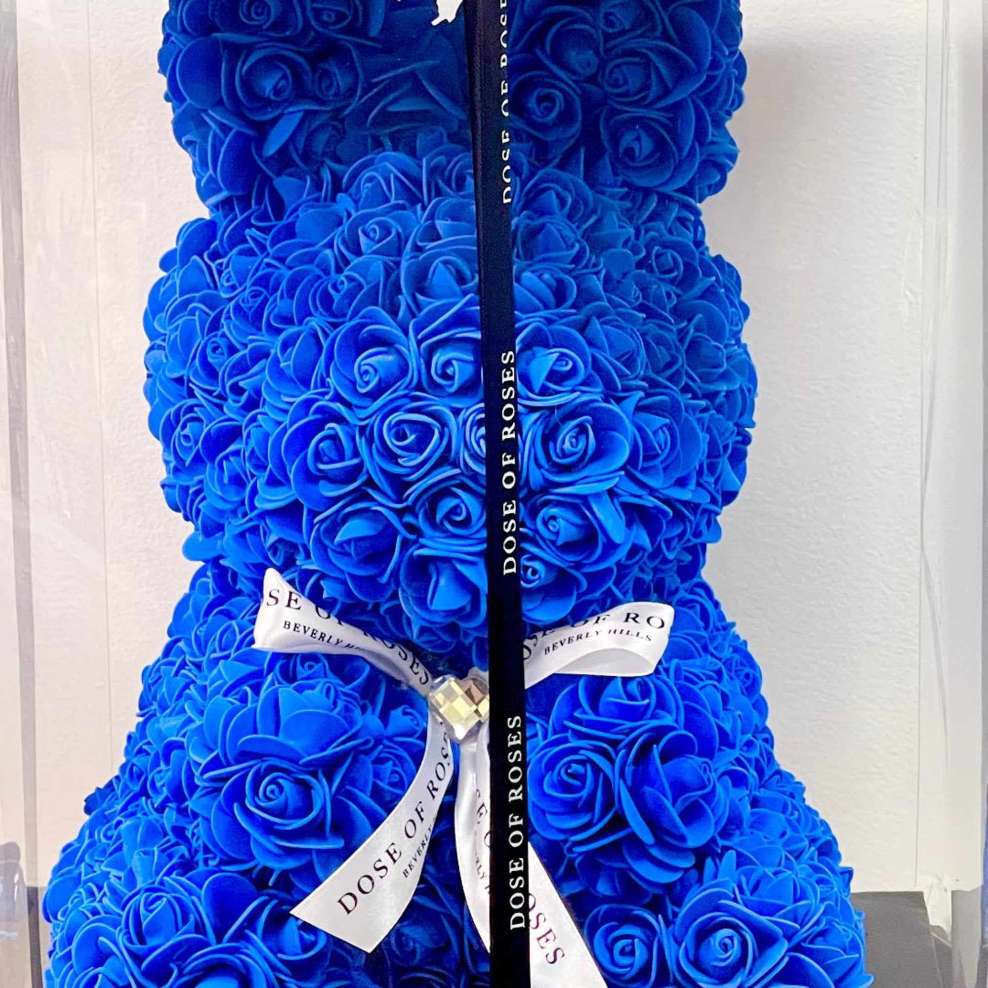 Blue rose teddy bear with ribbon bow in a gift box