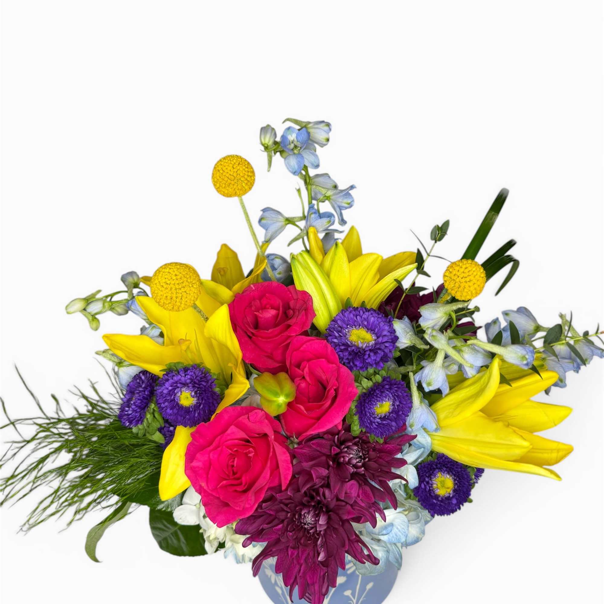 A whimsical garden-inspired arrangement featuring cheerful yellow blooms, lush pink roses, and