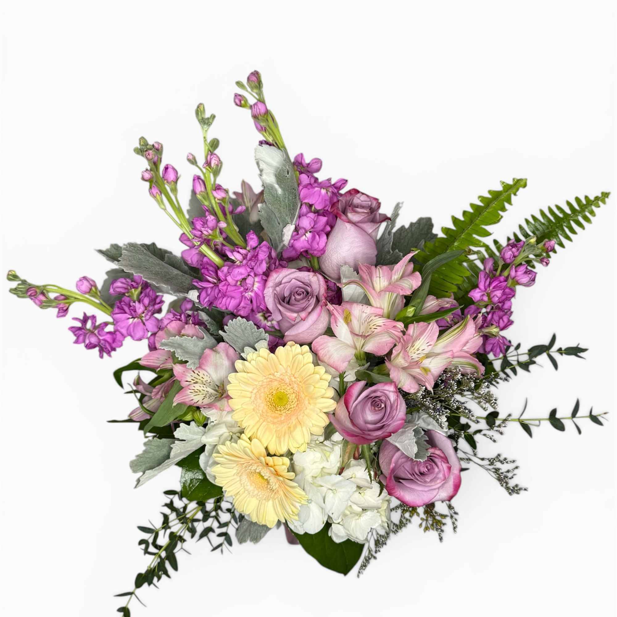A delicate blend of blush roses, creamy blooms, and soft lavender accents