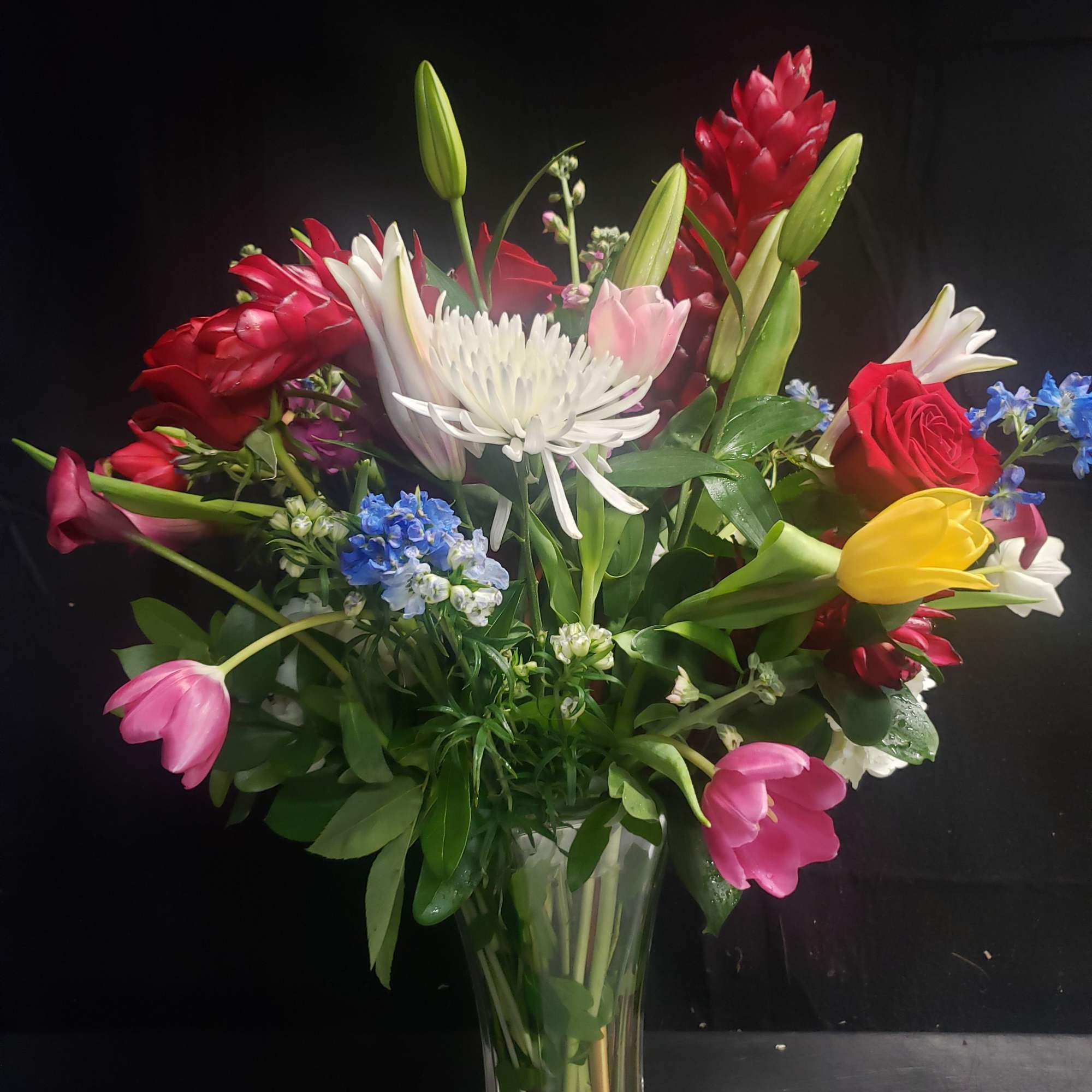 A lively, garden-style flower arrangement that brings a burst of color and