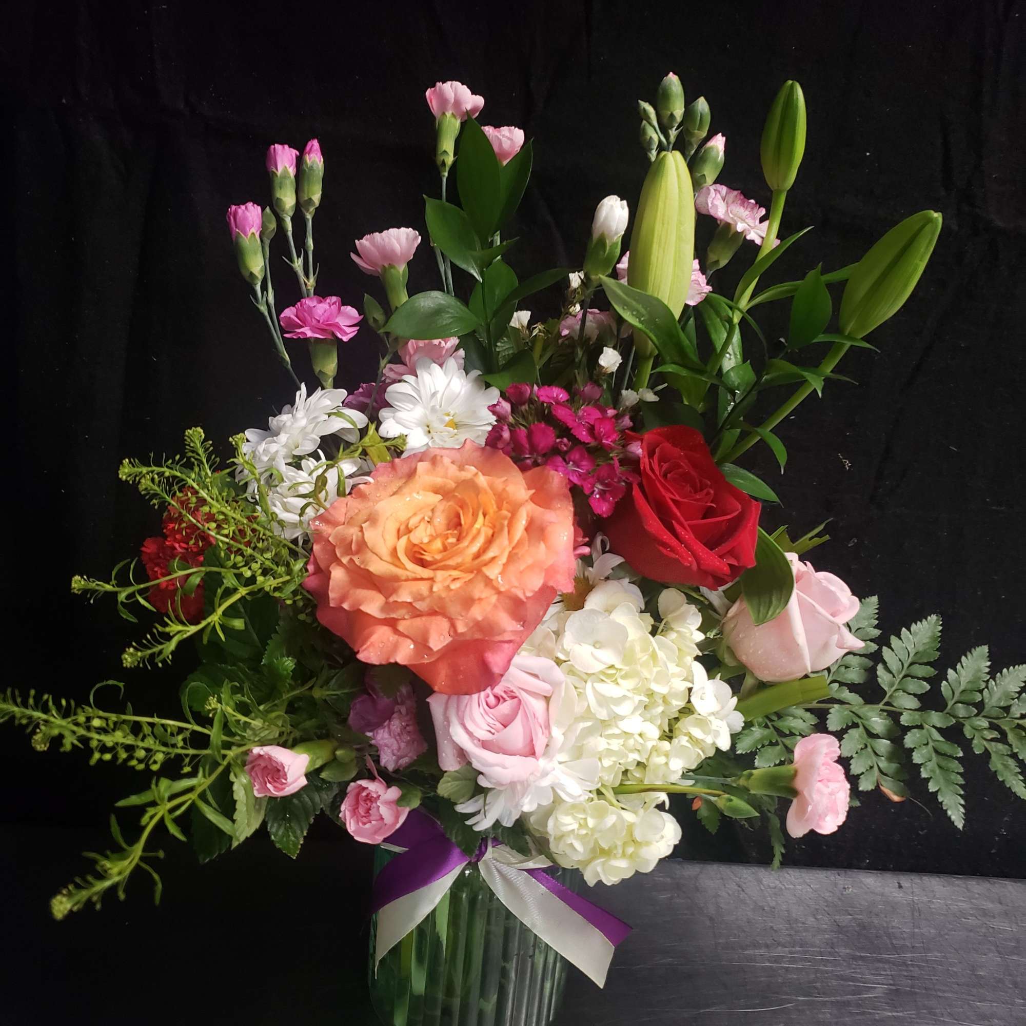 A large peach rose and a single red rose catch the eye