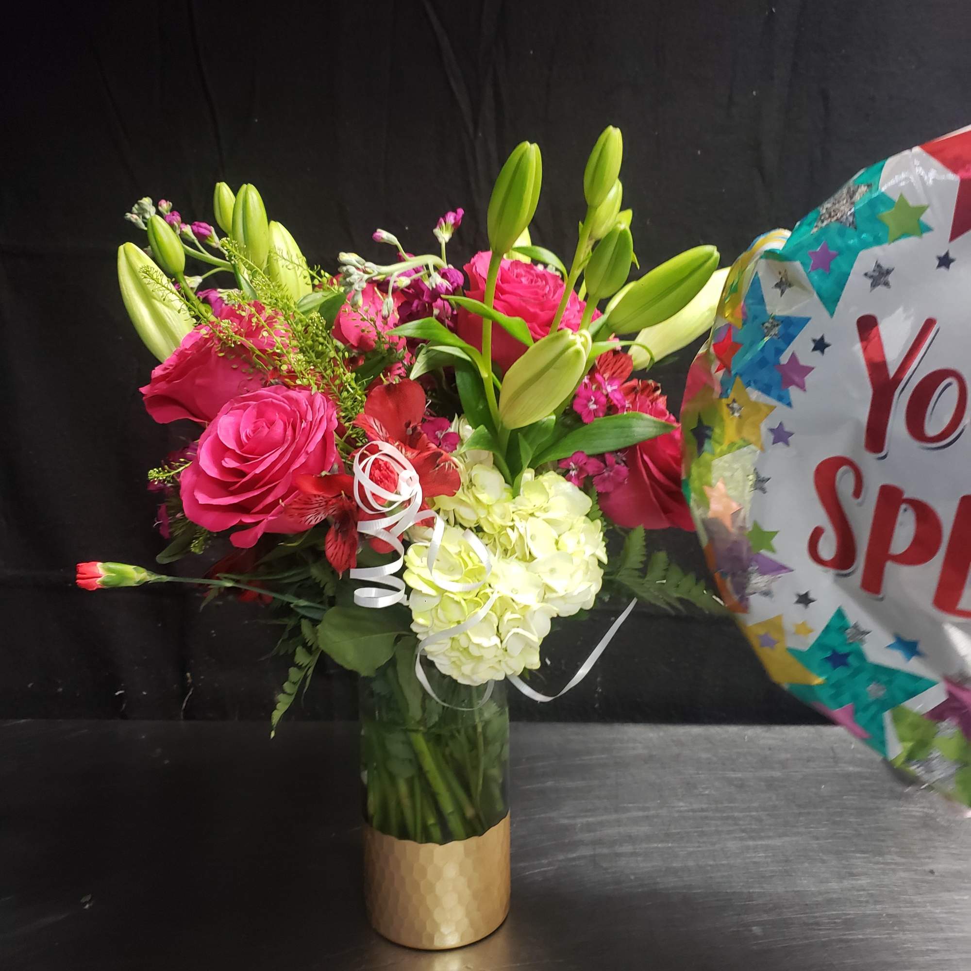 Vivid pink roses and pale green hydrangea create an instantly cheerful centerpiece-perfect