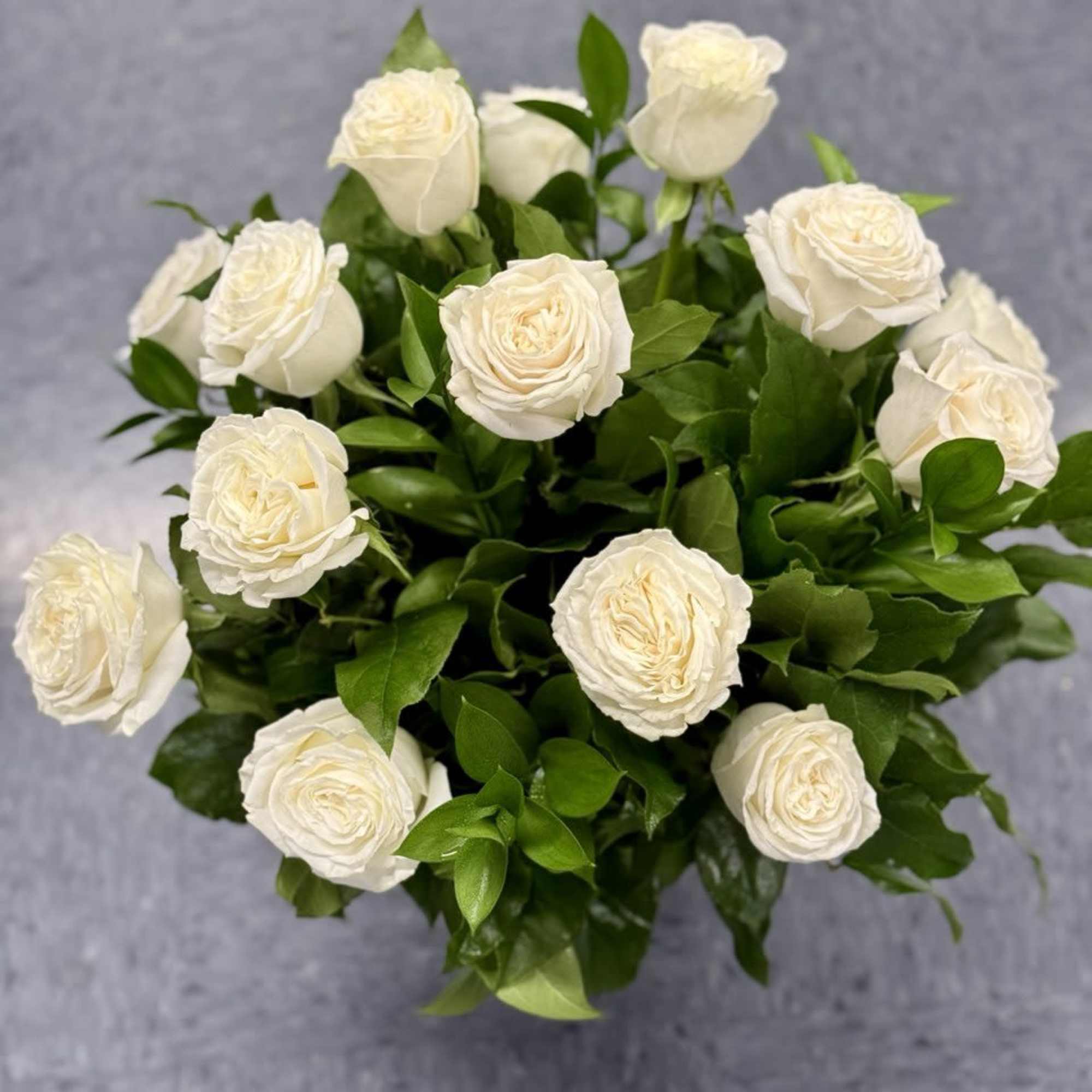 Bouquet of white roses with green foliage