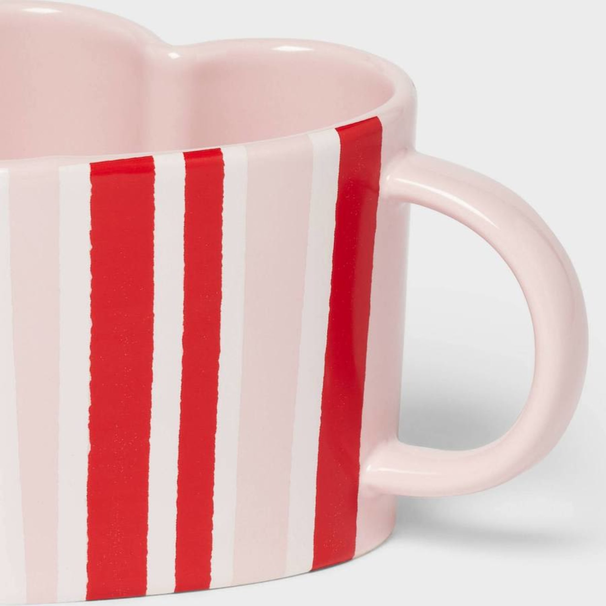 Pink striped ceramic mug with a handle