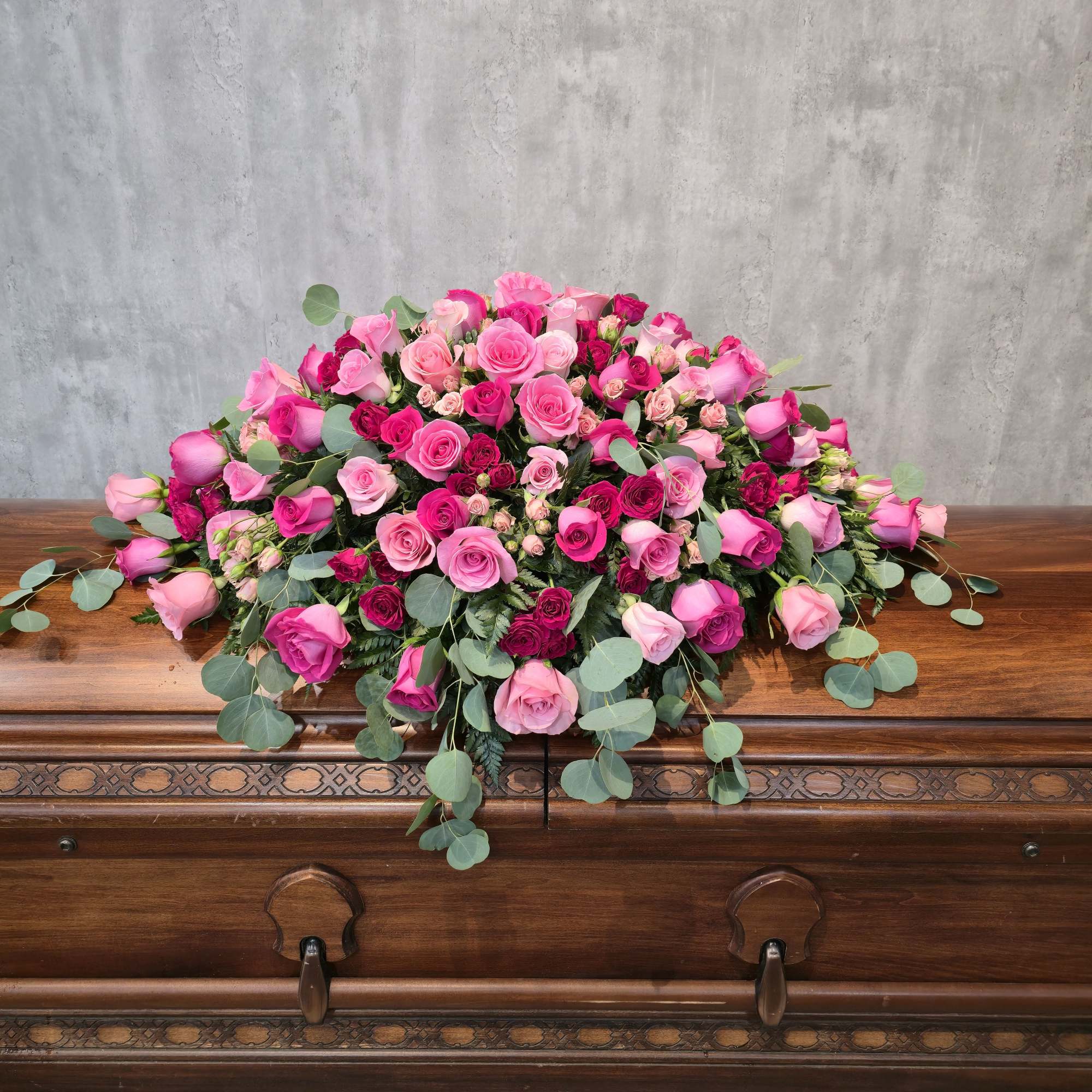 A gorgeous casket spray of white and pink roses.