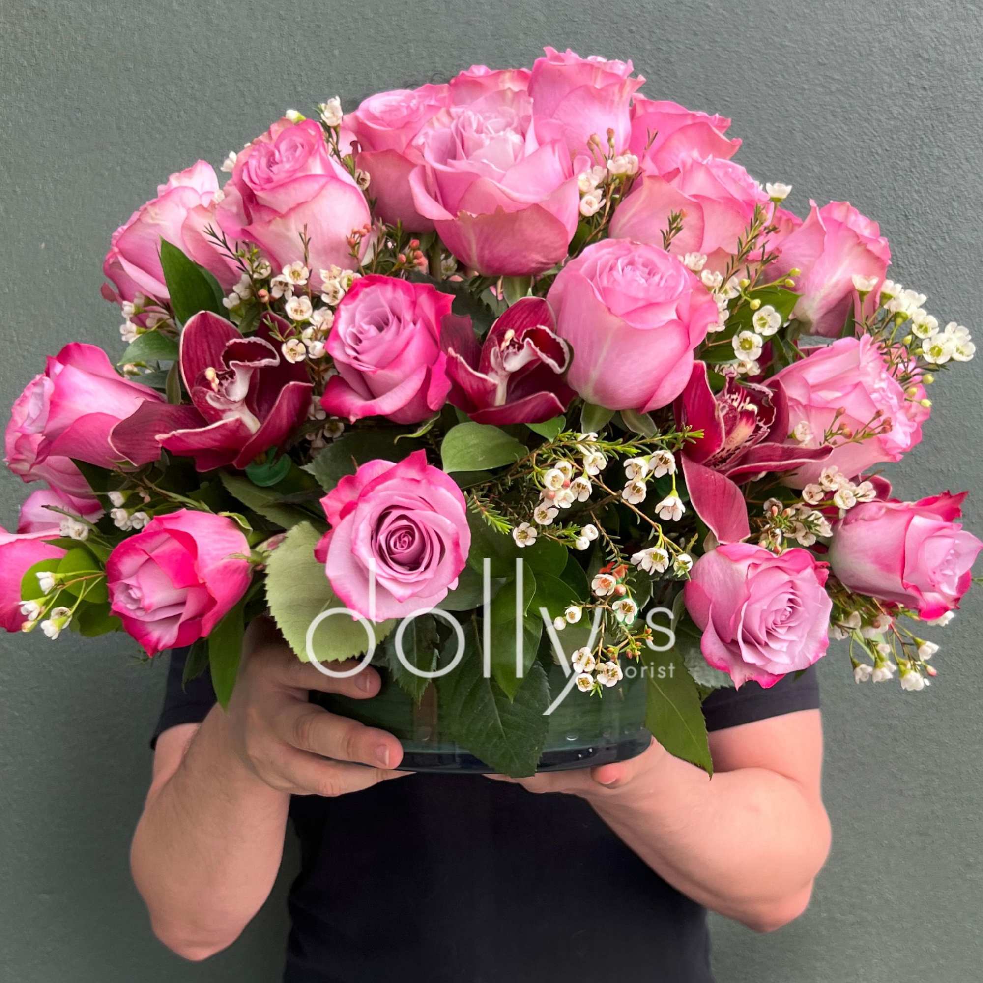 A lush dome of blush and hot-pink roses crowned with deep burgundy