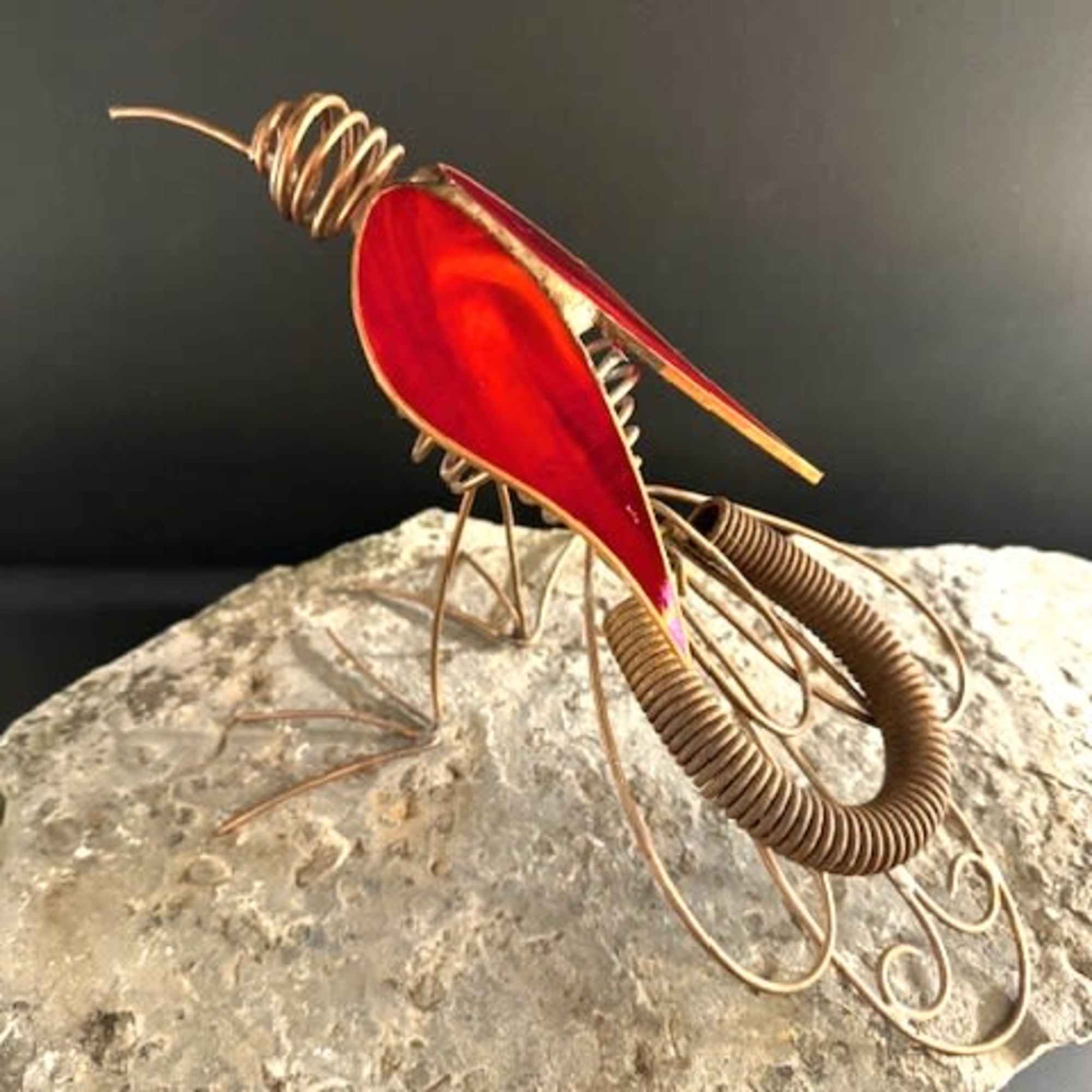 A bold sculptural flourish, this unique standing sculpture features a metal and