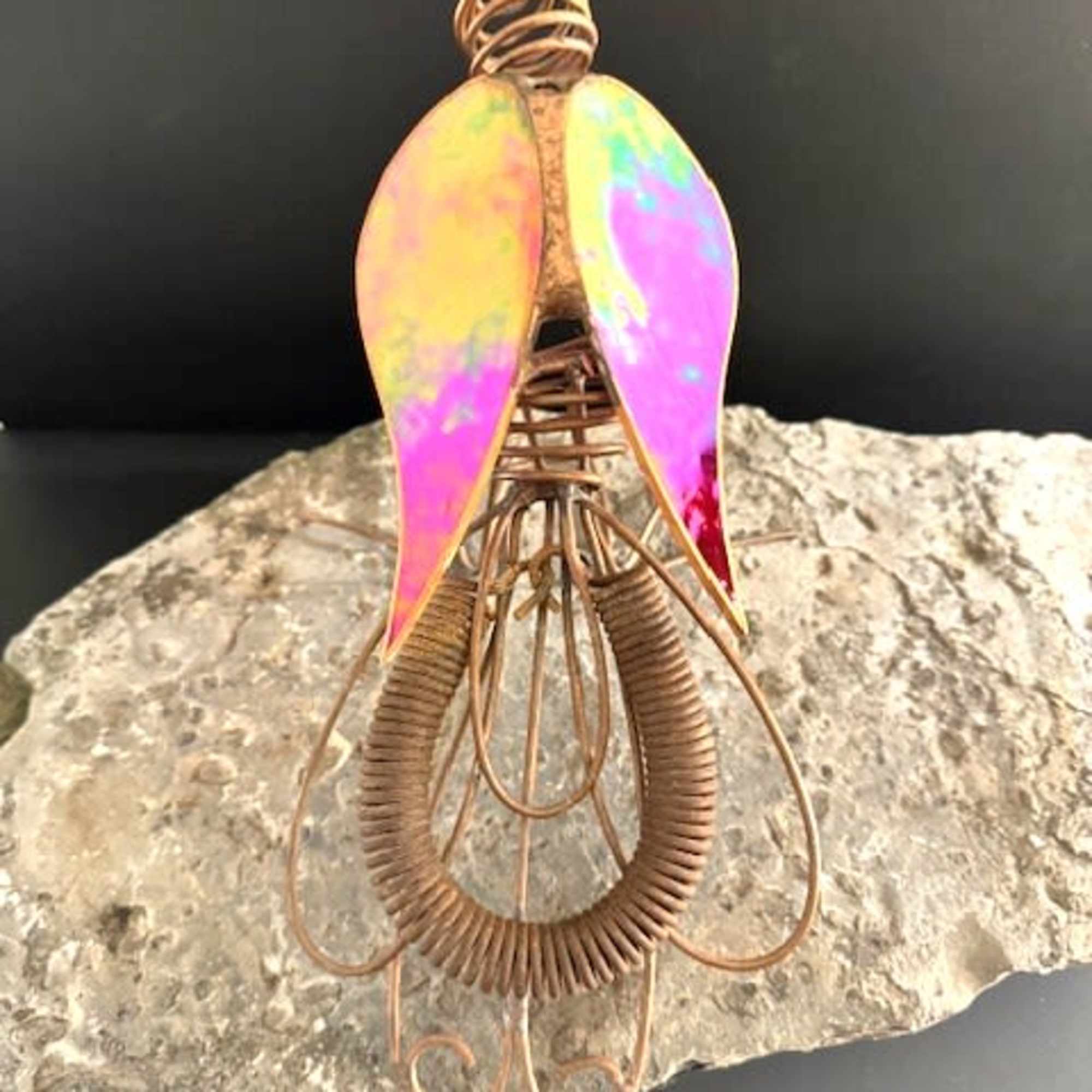 A bold sculptural flourish, this unique standing sculpture features a metal and