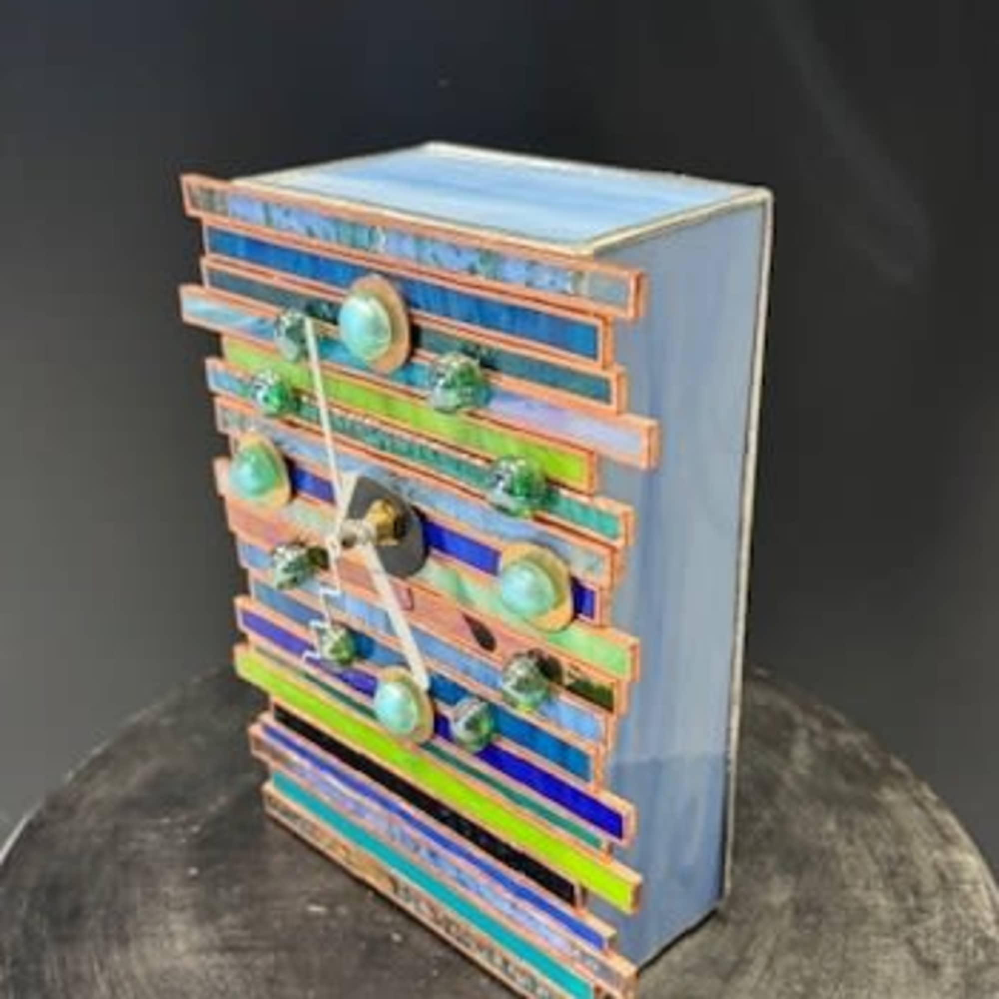 A playful, modern decorative clock arranged like a small art object makes