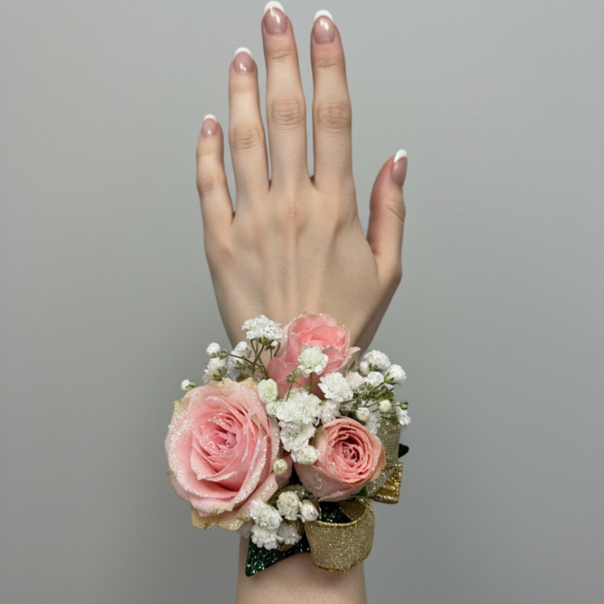 The perfect corsage for your "Golden Sweetheart" with three pink baby roses