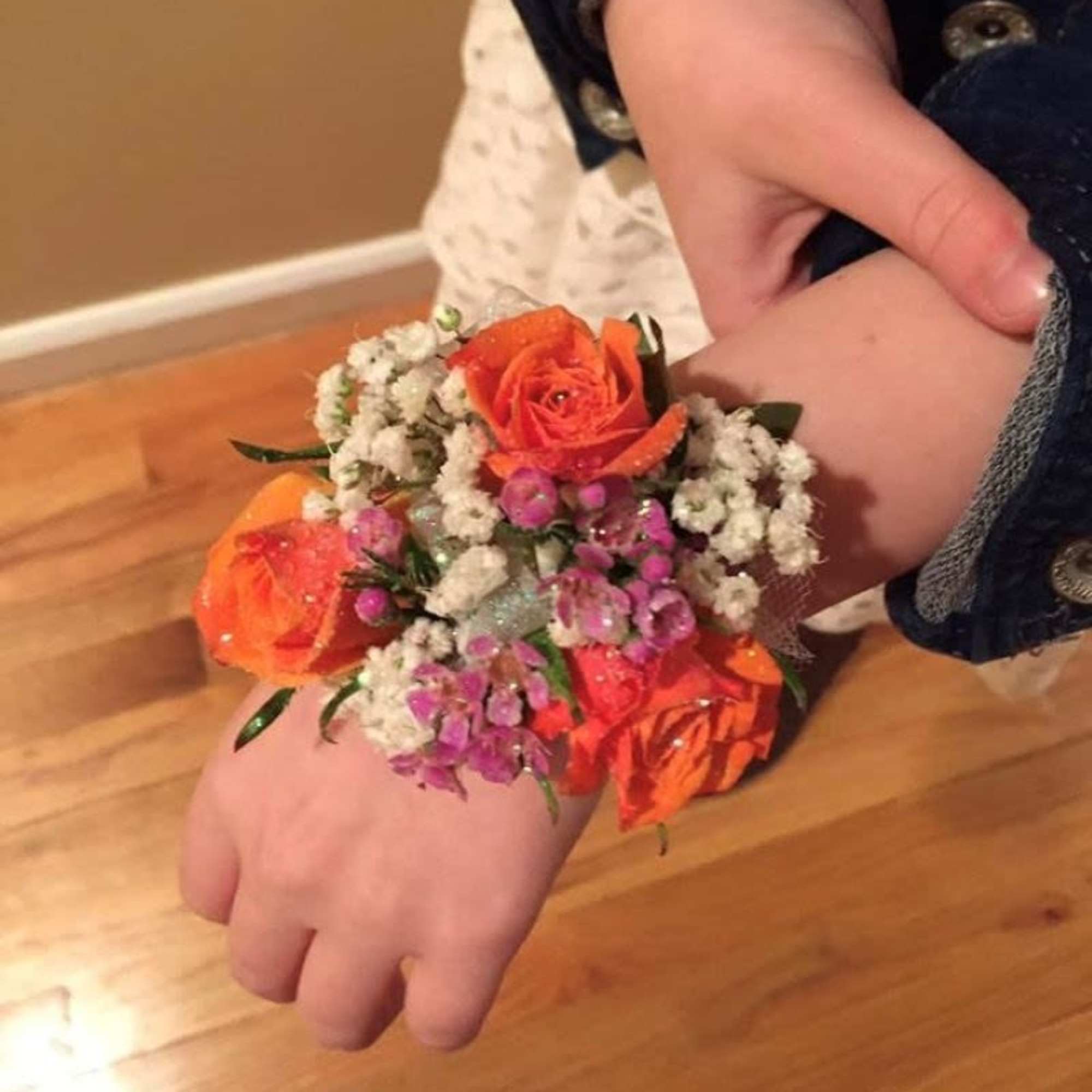 The perfect corsage for your "Golden Sweetheart" with three pink baby roses