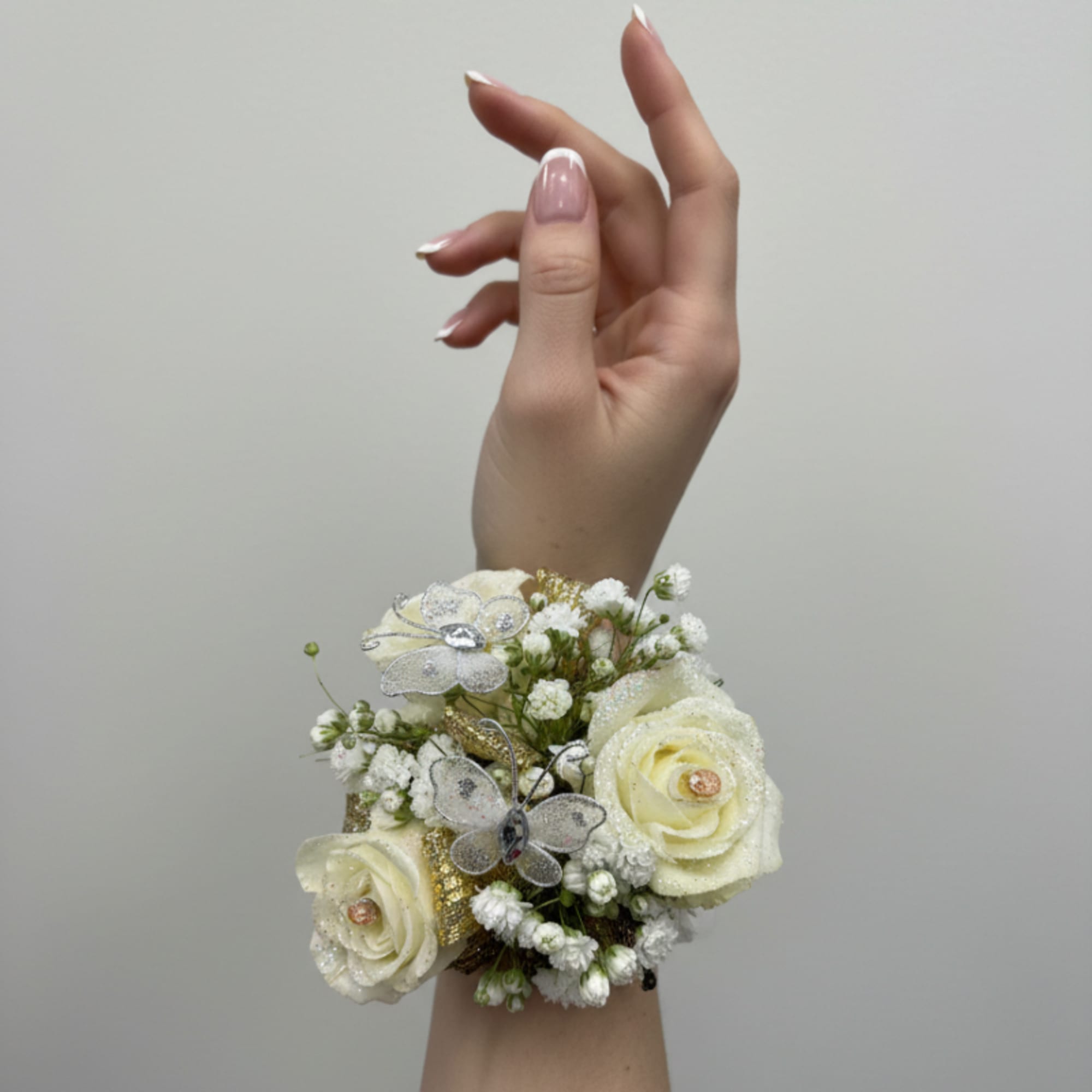 The perfect corsage for your "Golden Sweetheart" with three pink baby roses