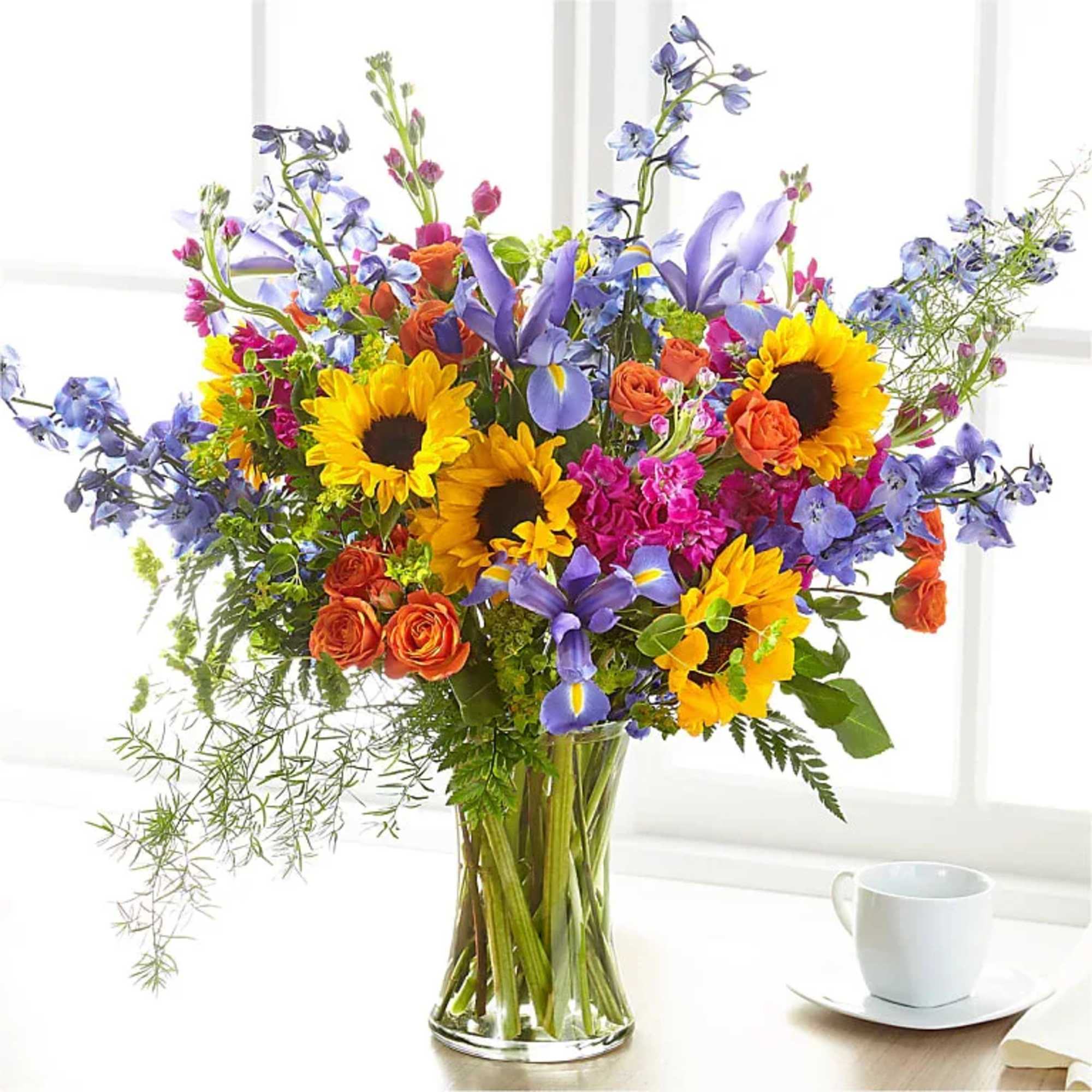 Bright yellow sunflowers take center stage in this Vivid Meadow flower arrangement