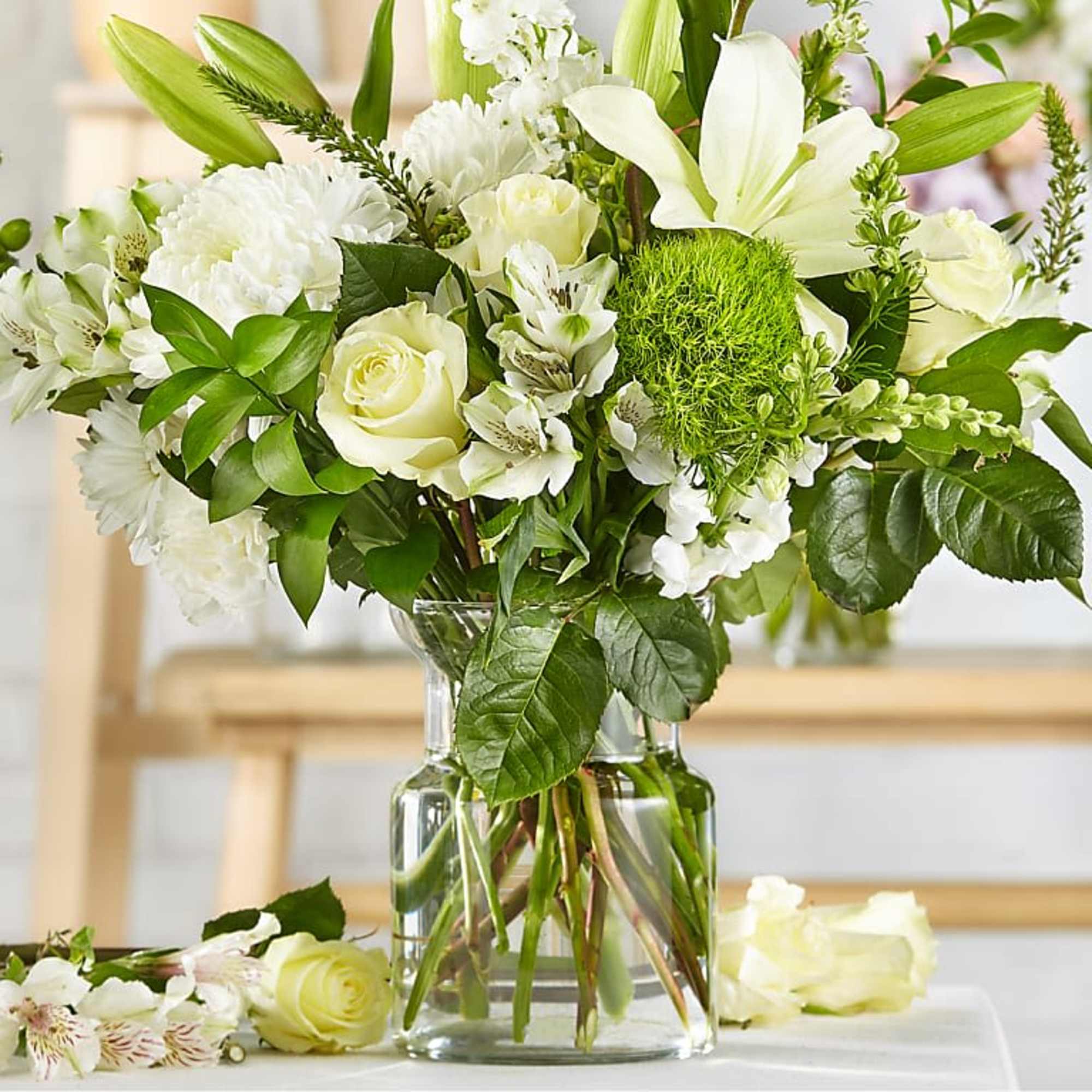 A cloud of white blooms-roses, lilies, hydrangea, chrysanthemums and daisy-like flowers-creates a