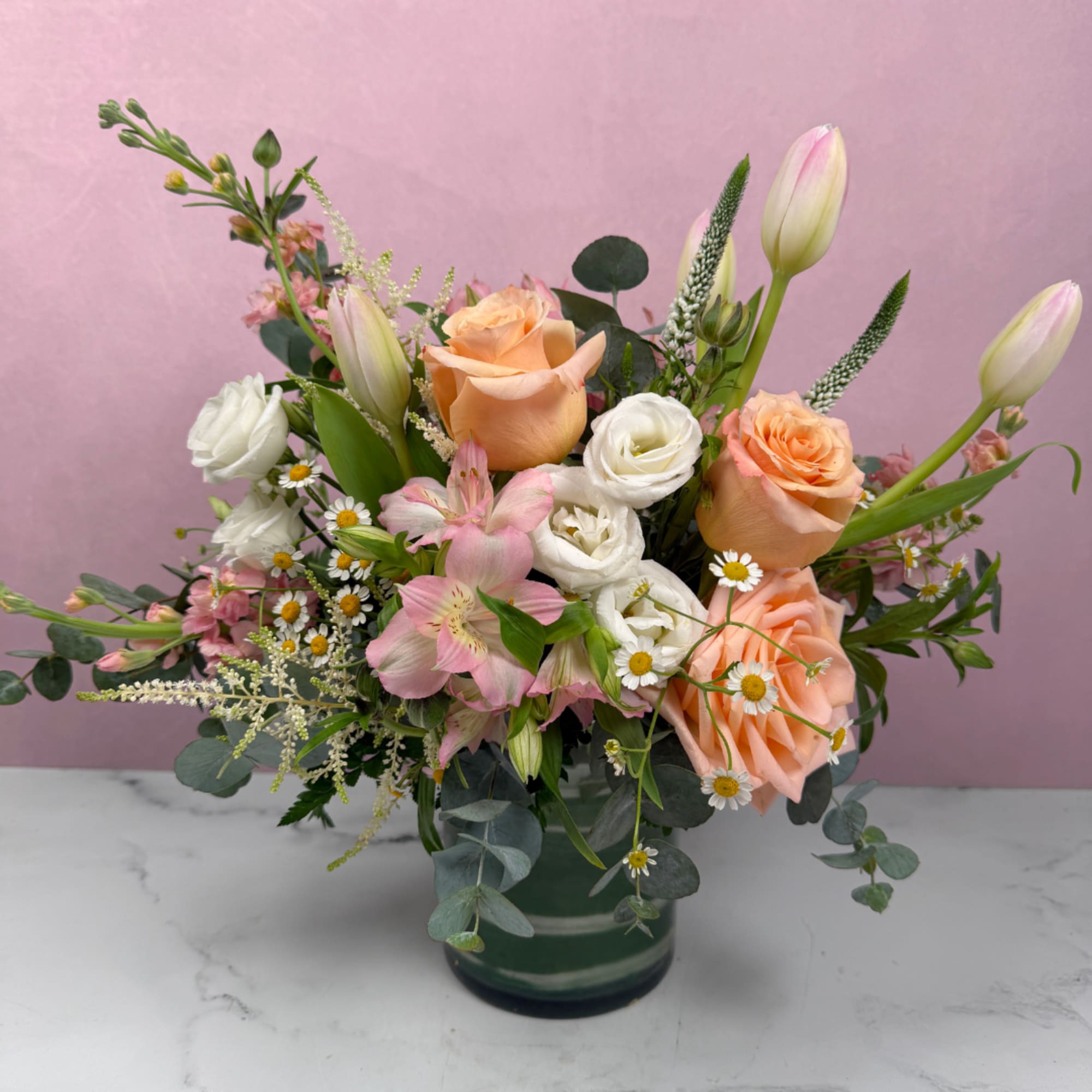 Blush, ivory, and soft pastel tones create a warm and comforting arrangement