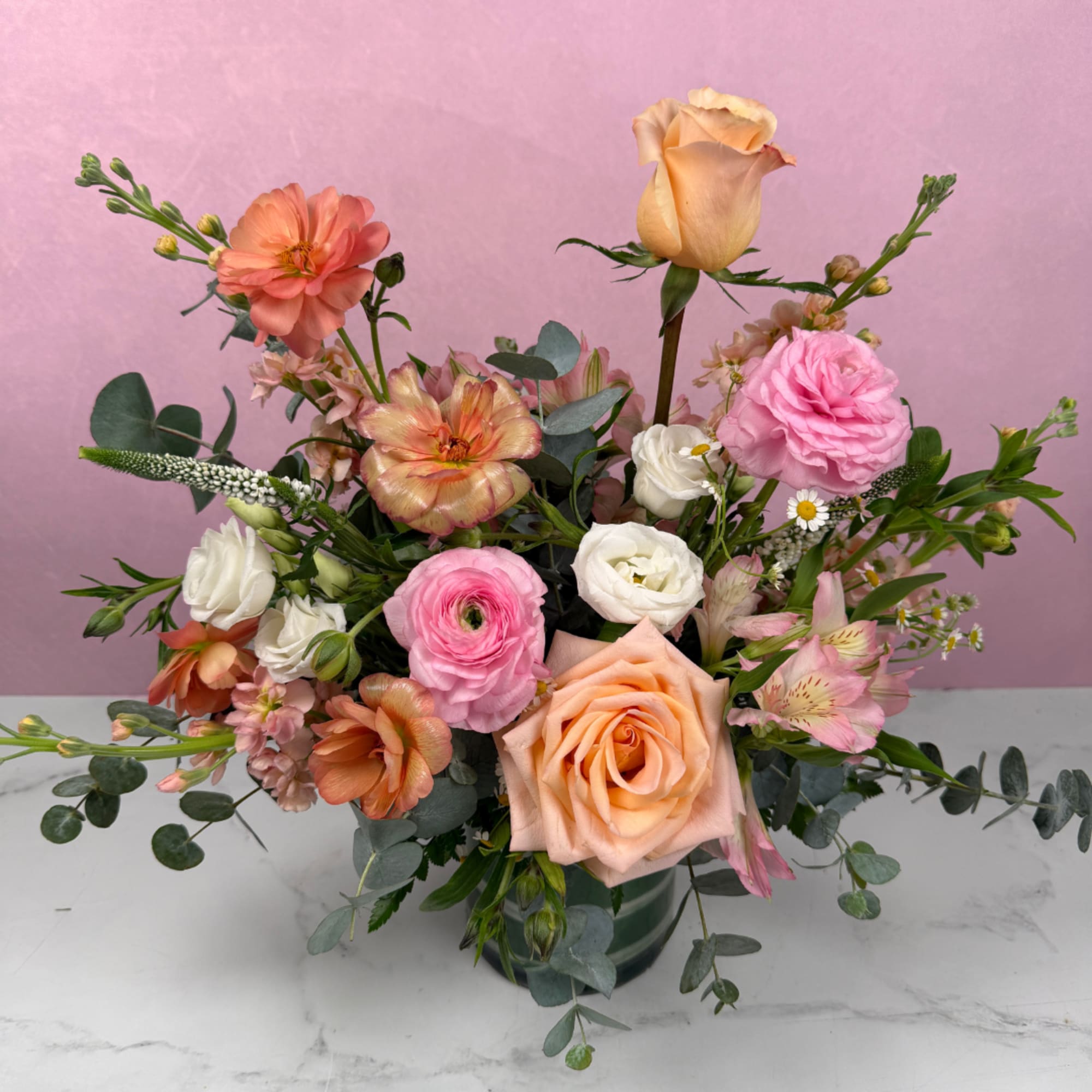 Blush, ivory, and soft pastel tones create a warm and comforting arrangement