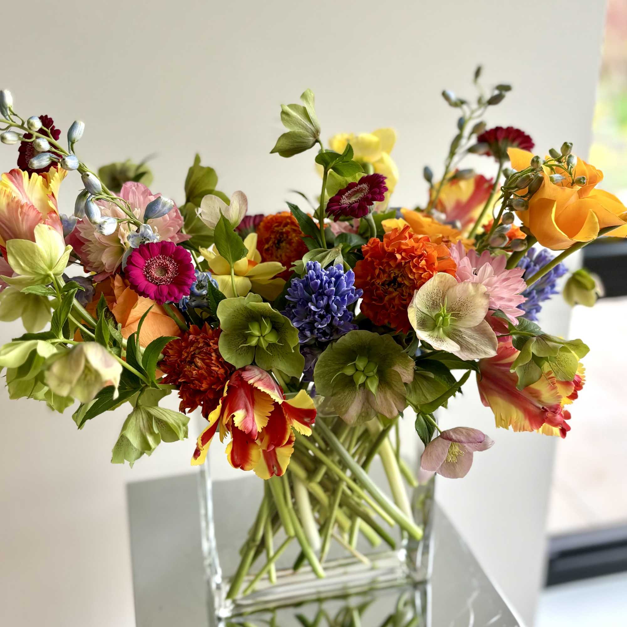 Mixed bouquet in a clear glass vase with colorful blooms