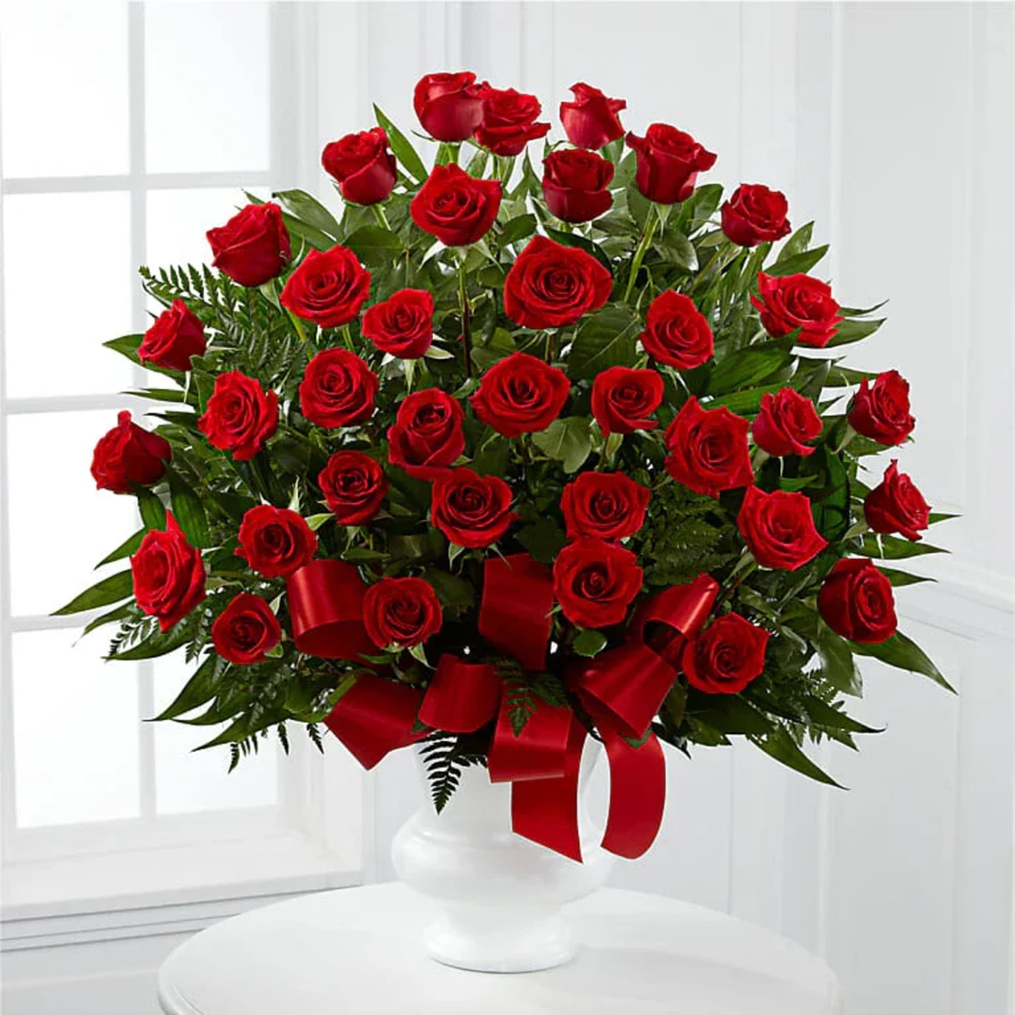 A lush dome of deep red roses makes an immediate impression-the perfect