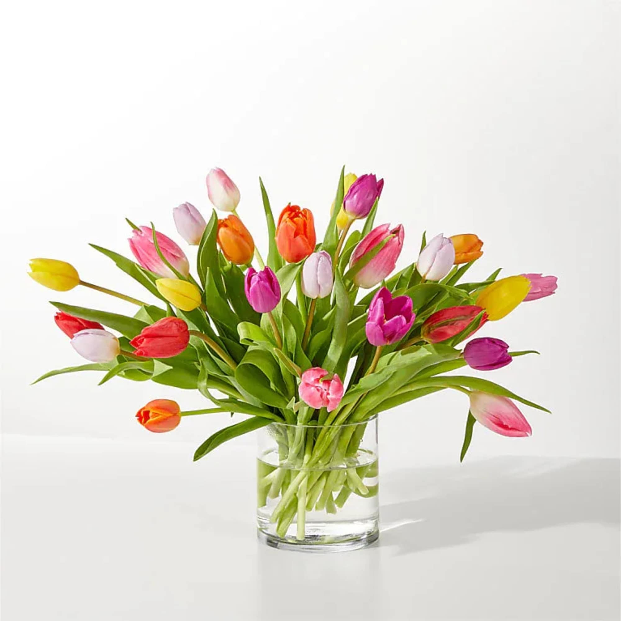 A cheerful burst of spring-this mixed-color tulip arrangement brings bright pinks, sunny