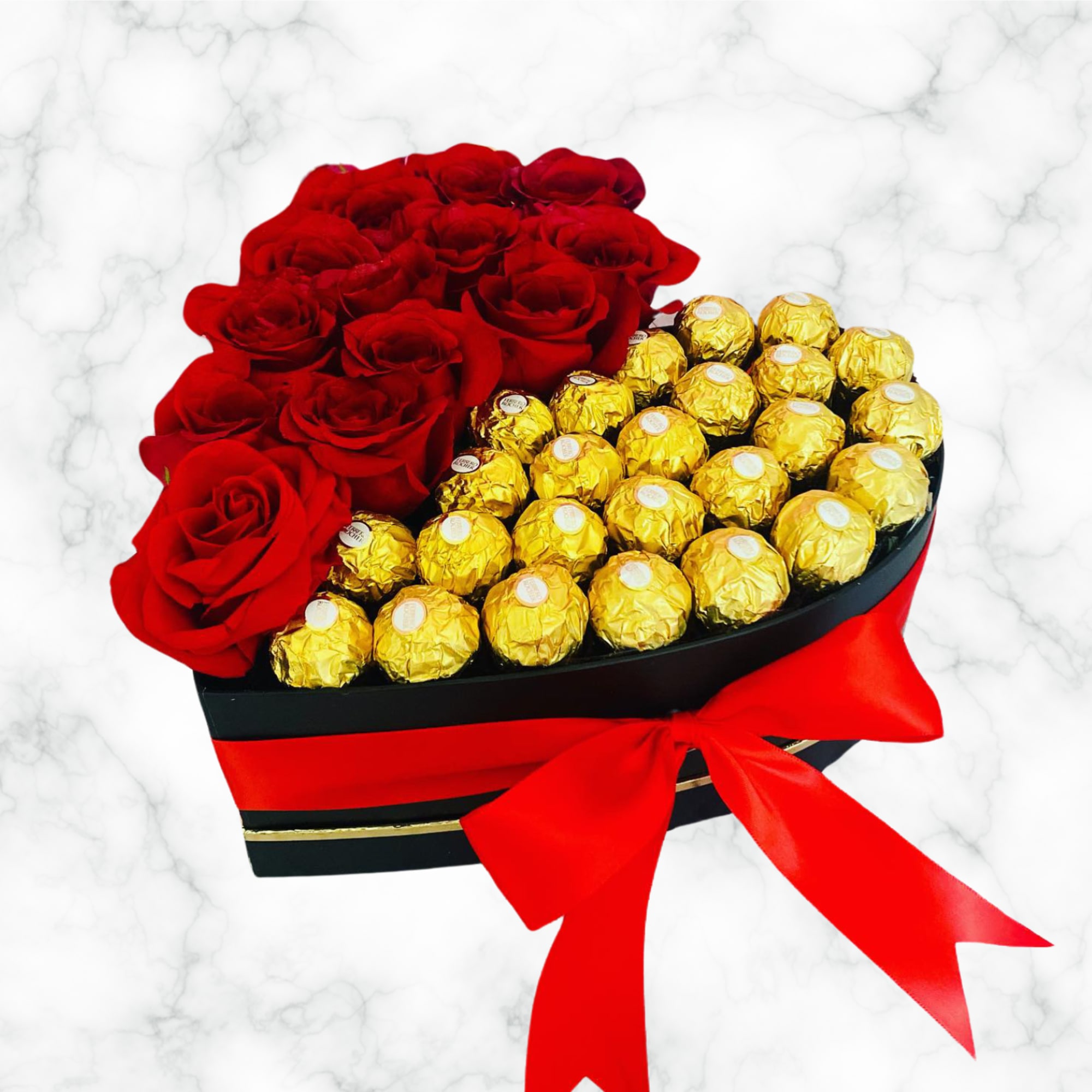 Heart-shaped box with red roses and gold-wrapped chocolates tied with a red ribbon