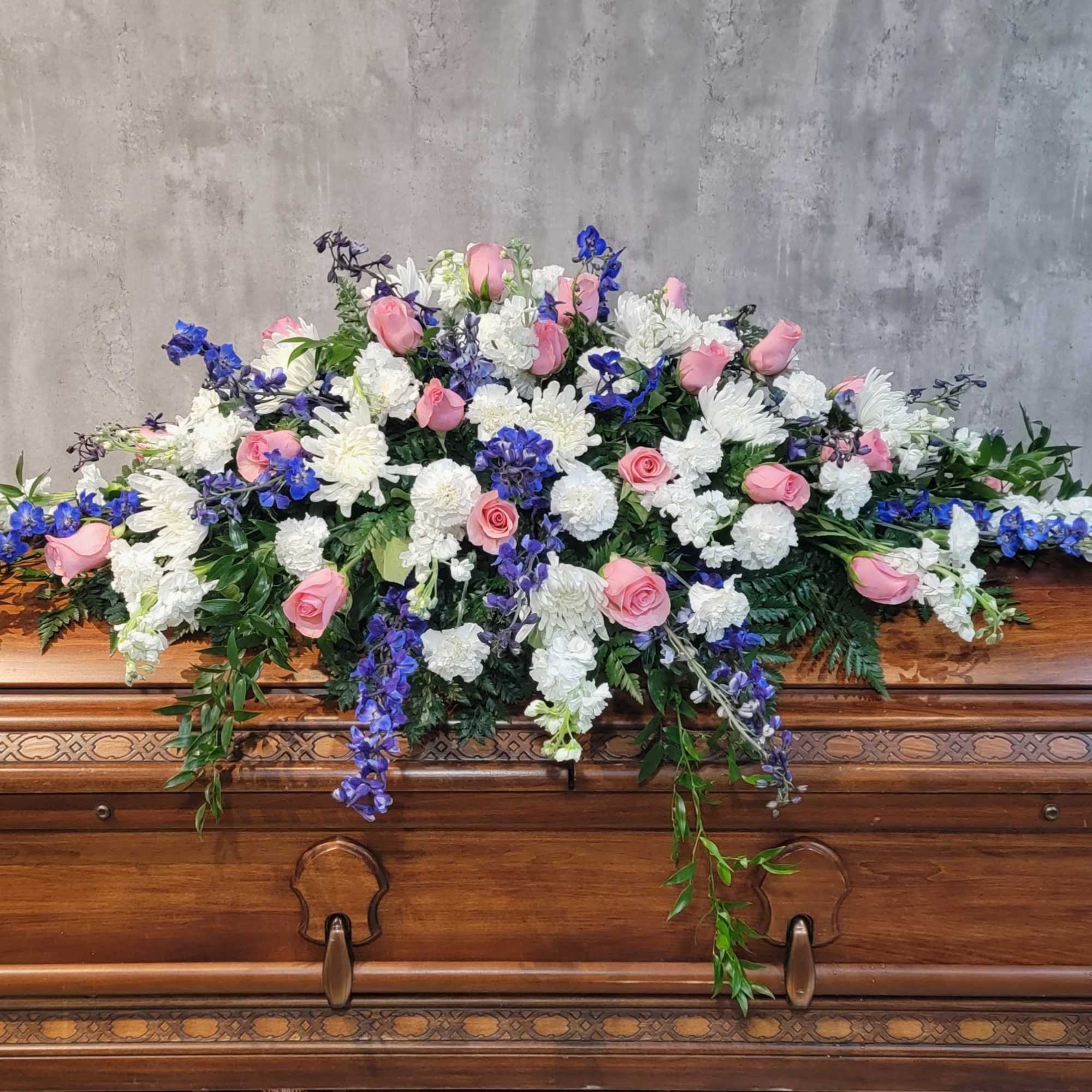 Blue and white full casket spray.