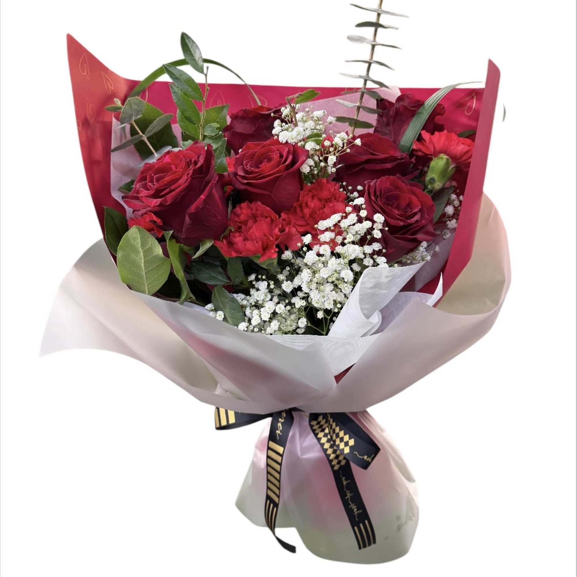 Bouquet of red roses with white filler flowers wrapped in pink paper
