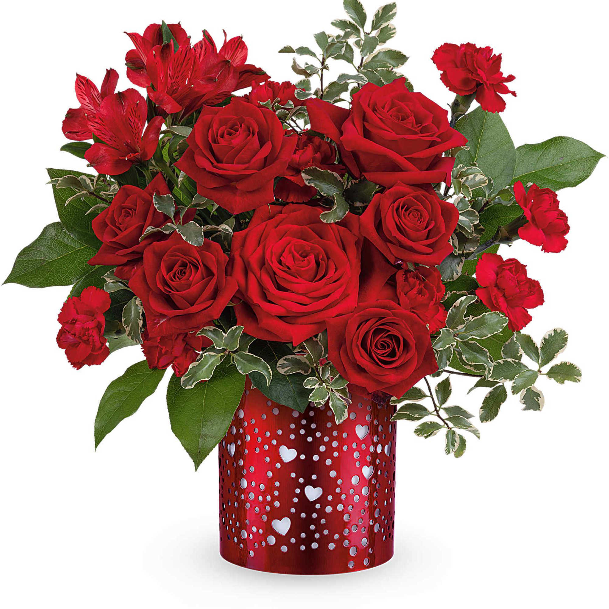 Red roses and carnations in a heart-patterned red vase
