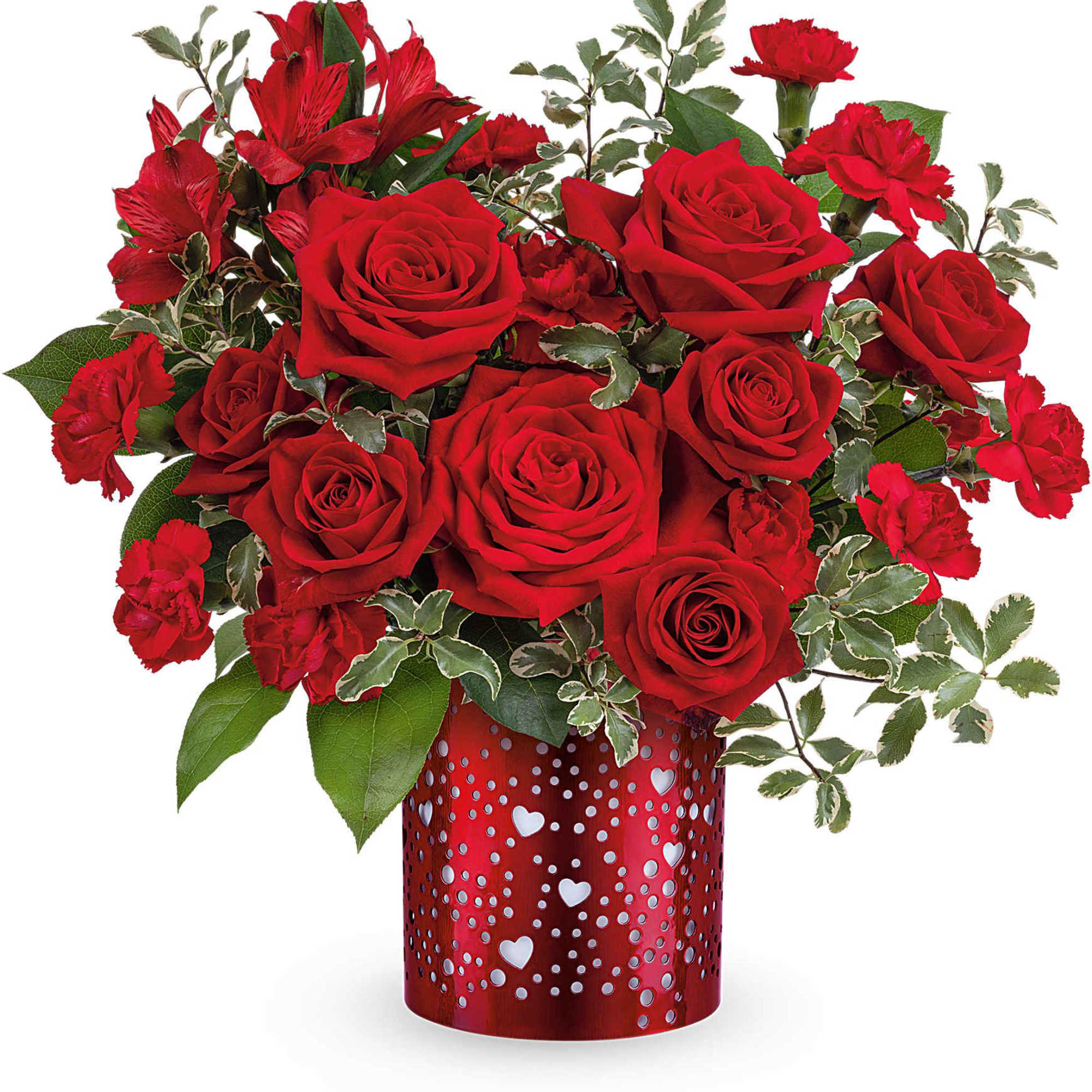 Red roses and carnations in a red heart-patterned vase