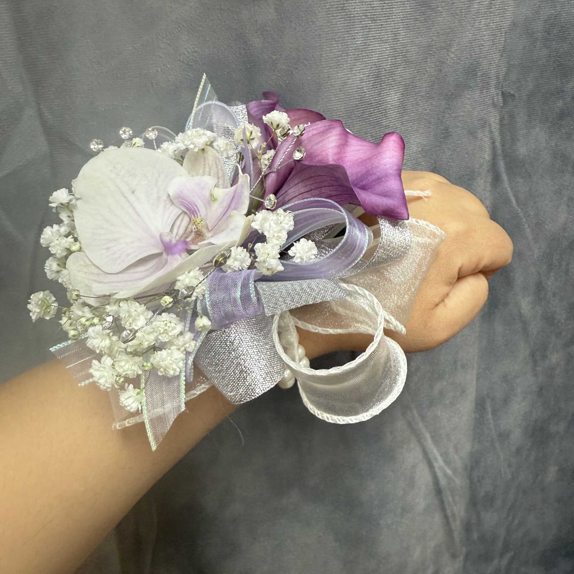 Purple calla lilies and lavender orchids, rhinestone picks and layered ribbons-an elegant