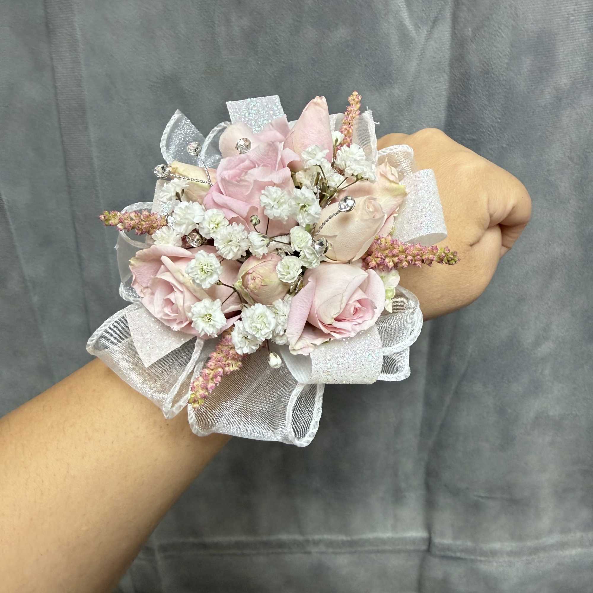 pink spray roses with pink and white filler, sheer ribbons and rhinestone