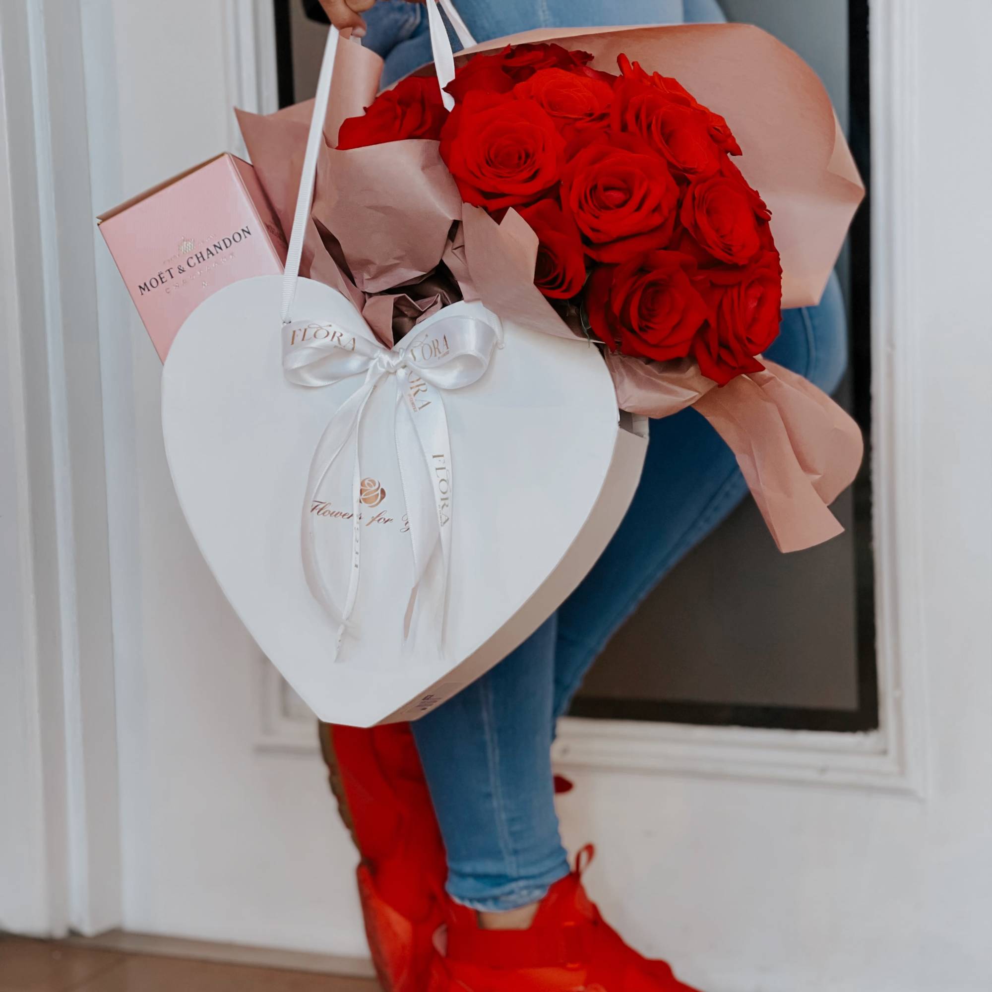 Red rose bouquet in a heart-shaped gift box with a pink champagne box