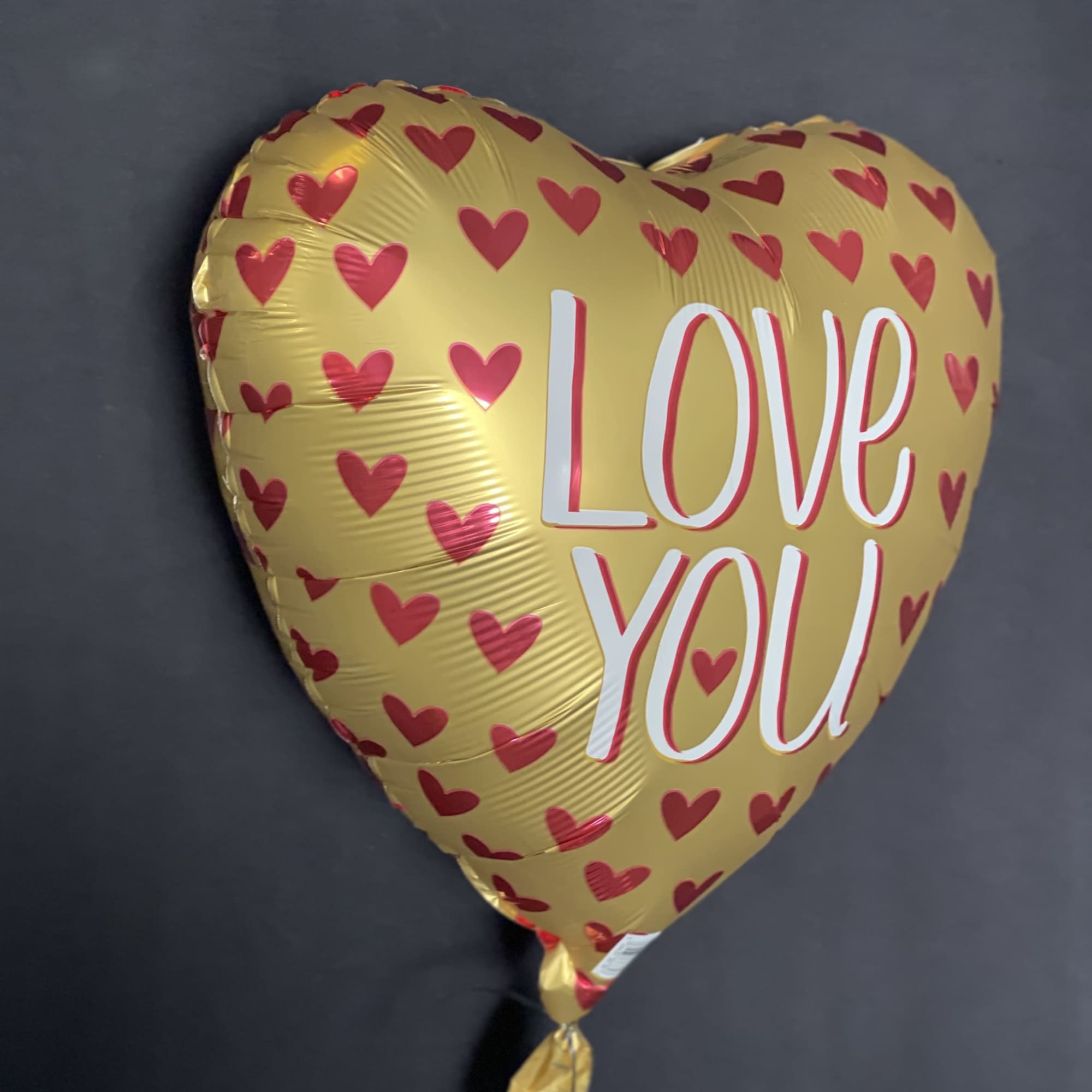 Express your love with the Love You Gold Heart Balloon, a perfect