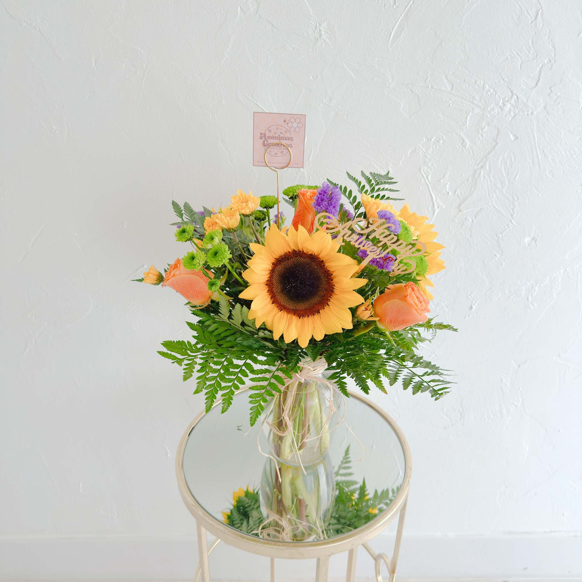 Un arreglo alegre y vibrante que combina girasoles radiantes con rosas en