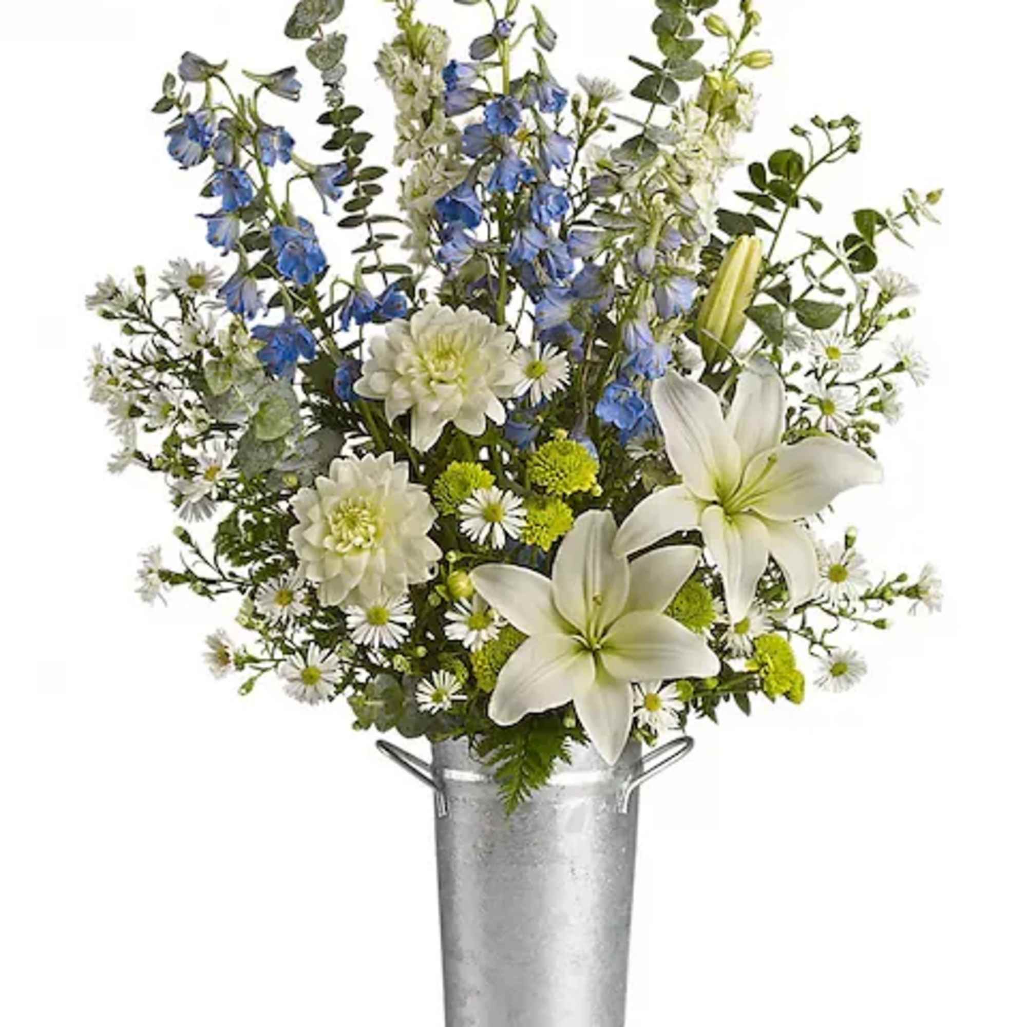 White lilies and blue flowers in a tall metal bucket