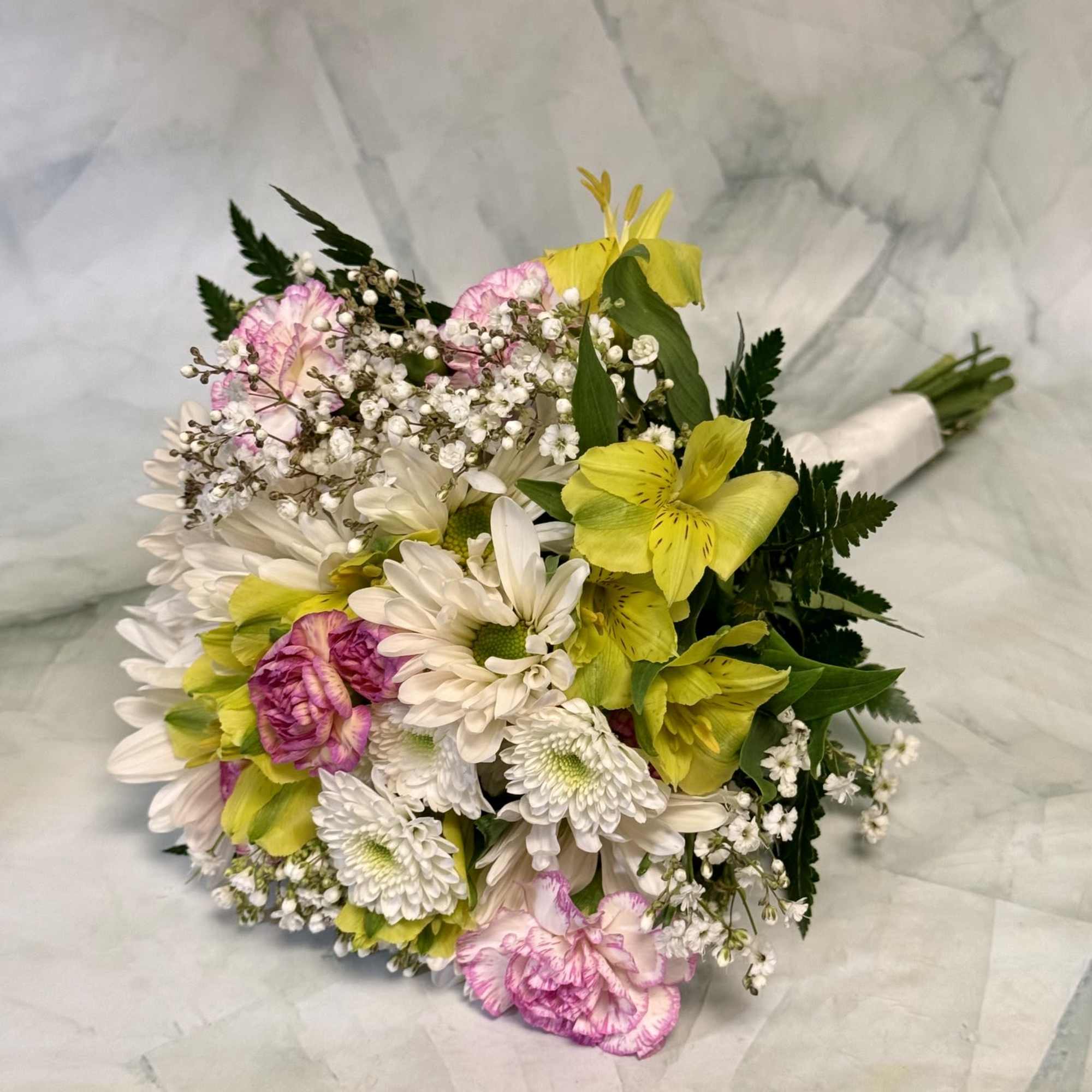 A bright, hand-tied prom bouquet that feels like a pocketful of spring